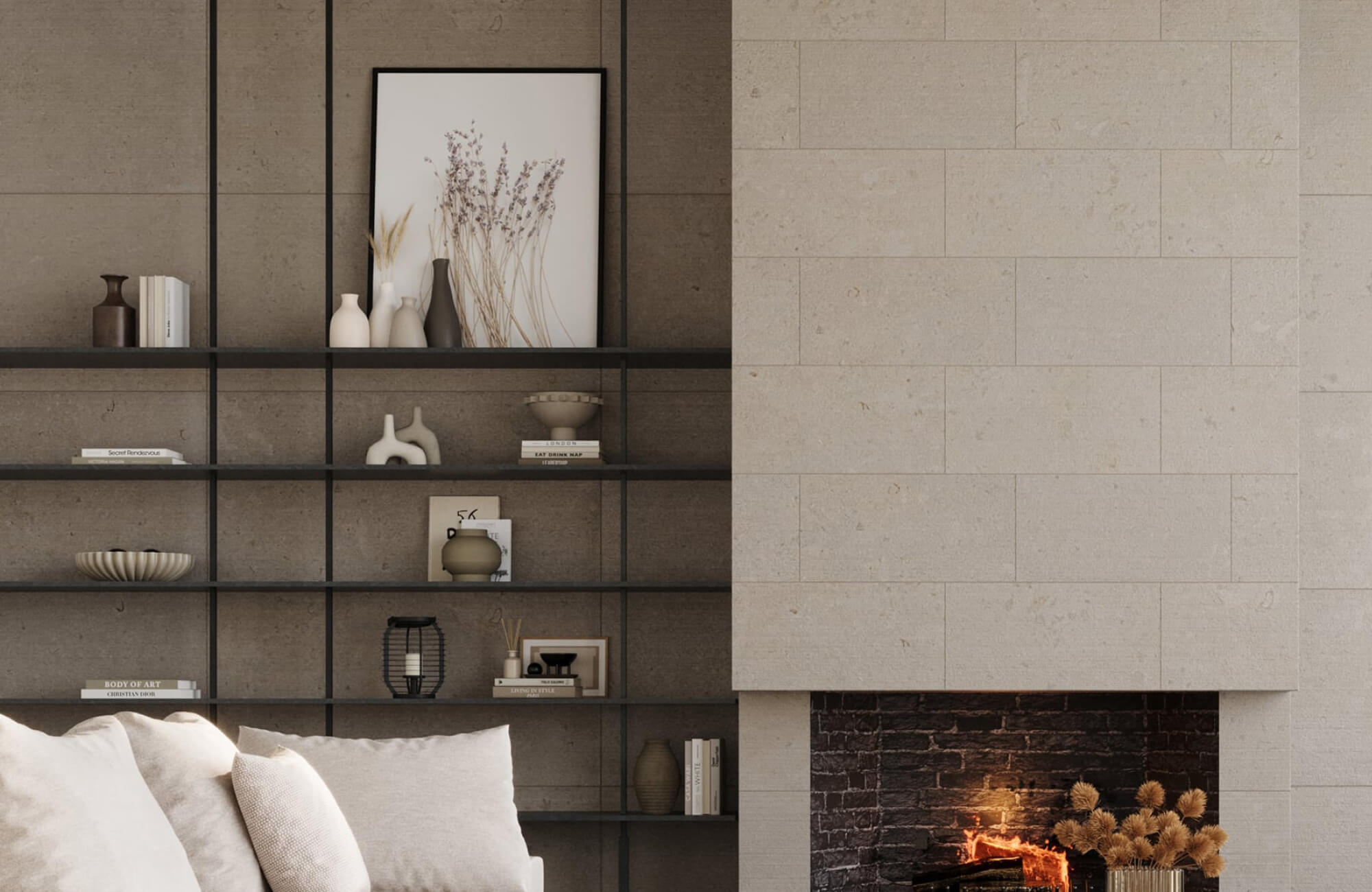 Large neutral framed textile artwork above a fireplace in a warm living room with built-in shelving.