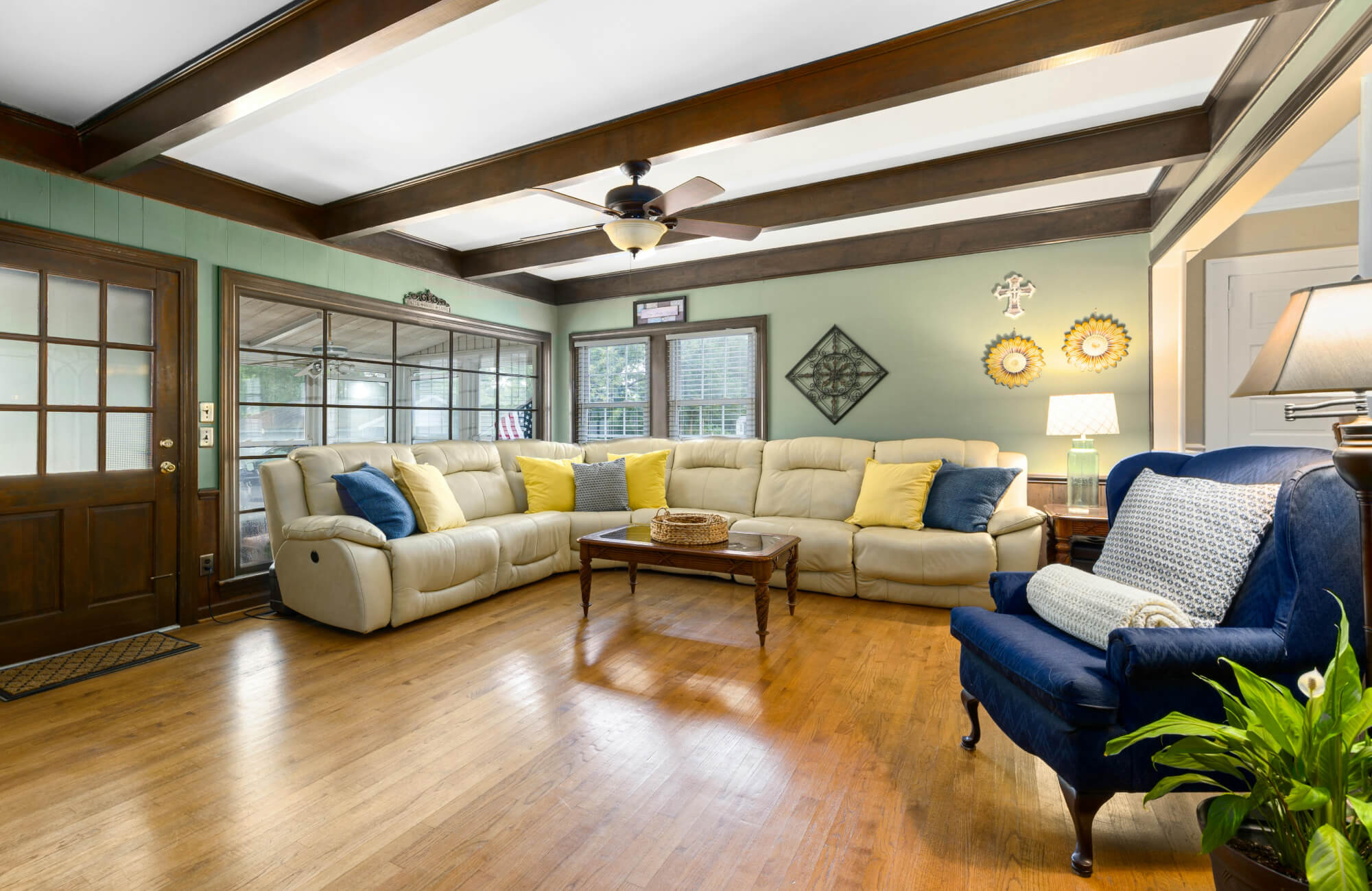 Spacious living room with curved sectional sofa styled with evenly spaced pillows along the back, demonstrating symmetrical placement for a balanced and cohesive look.
