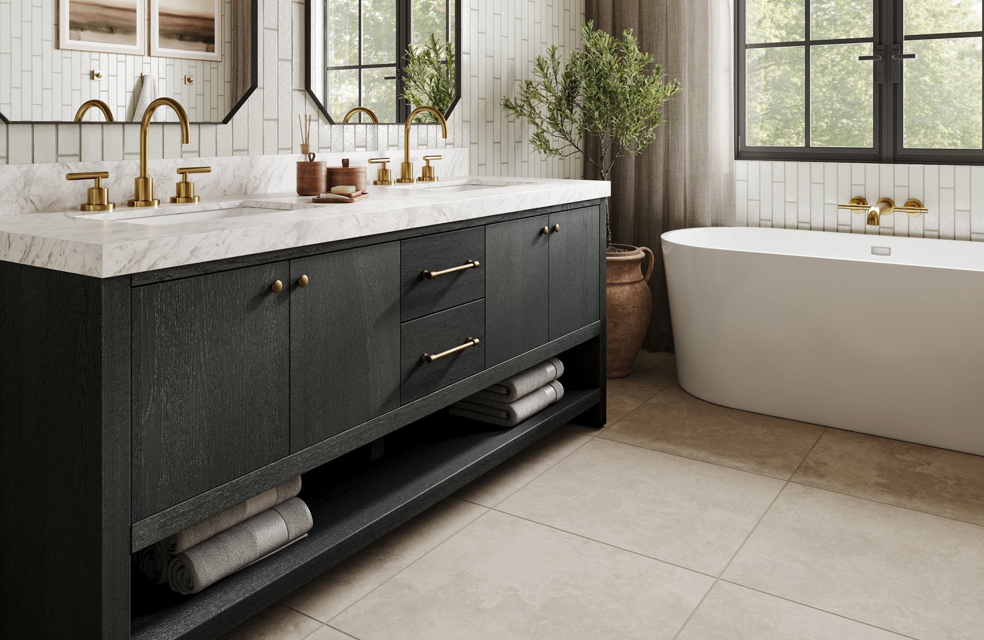 Black bathroom vanity with brass hardware and marble top beside a freestanding tub and tiled backsplash.