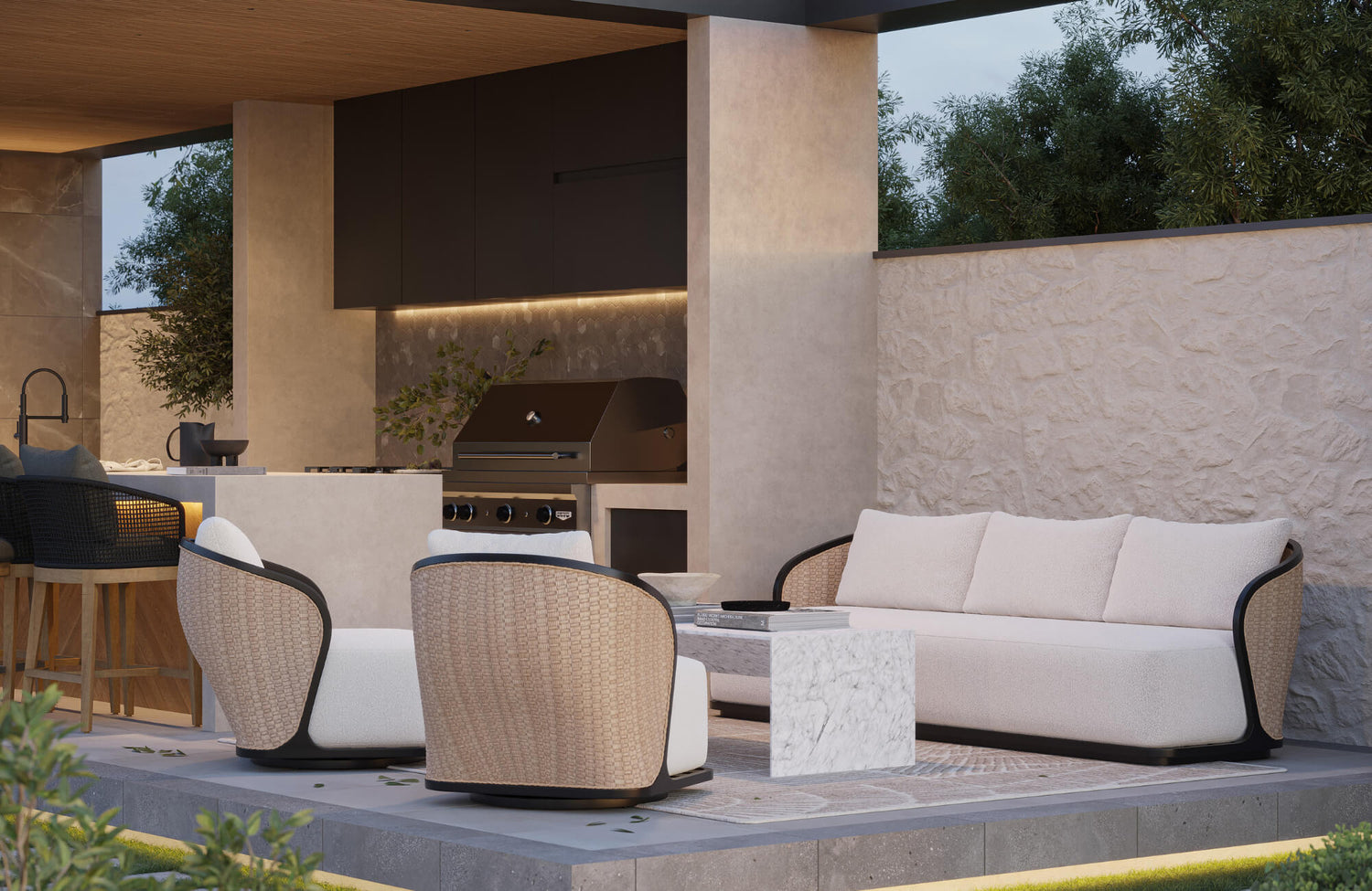Modern outdoor lounge with curved seating, neutral cushions, and built-in kitchen, blending comfort and sleek architectural design.
