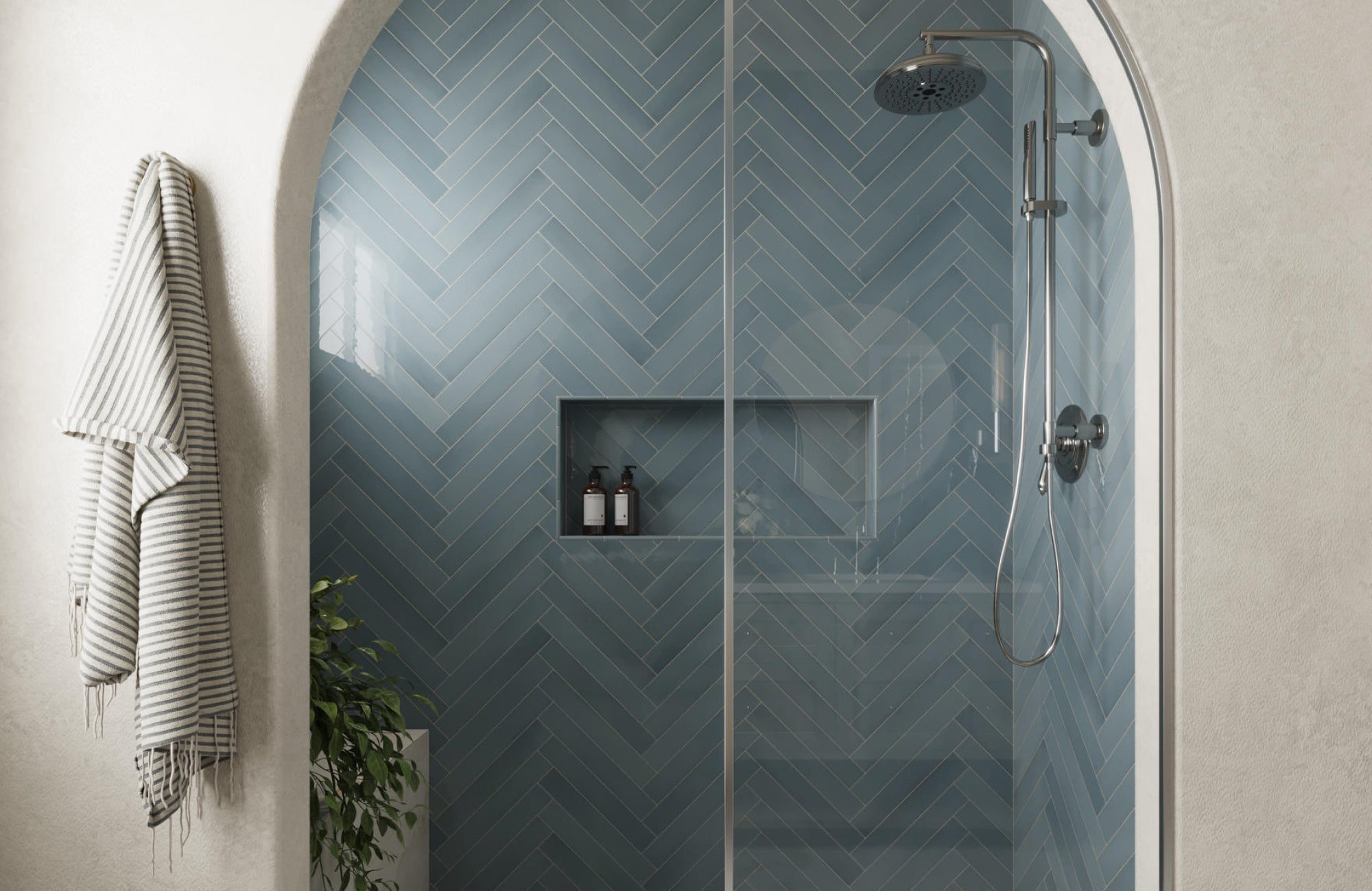 Bathroom shower with blue herringbone tile pattern creating a modern and stylish accent wall design.
