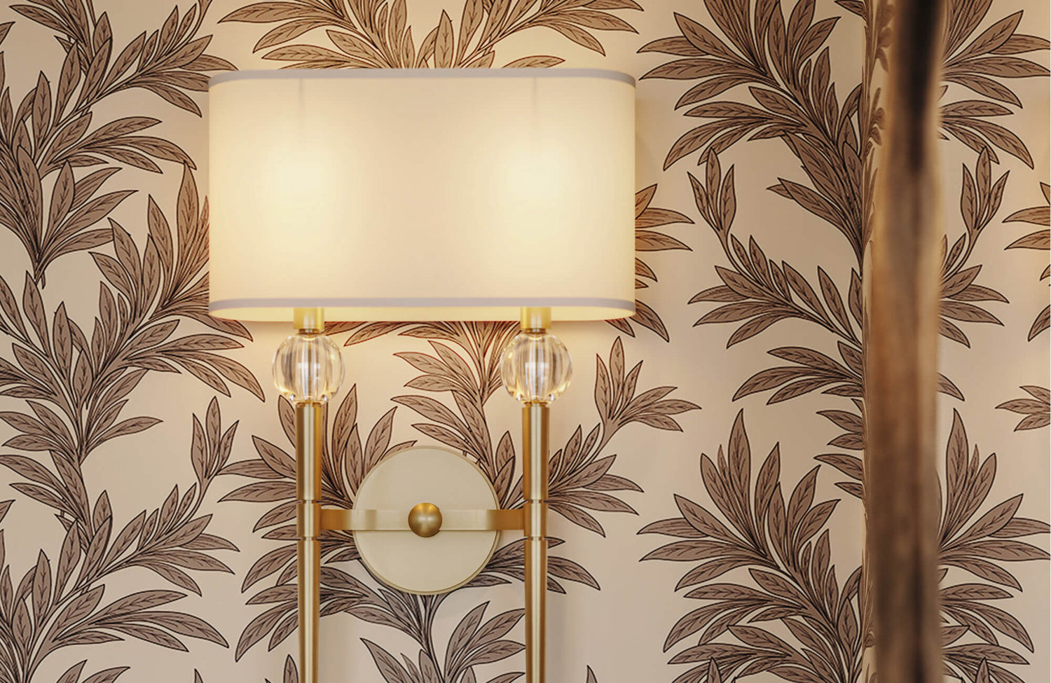 Botanical nature wallpaper with repeating leafy branch motifs in warm brown tones on a soft beige background, creating an elegant, organic pattern behind a wall sconce.