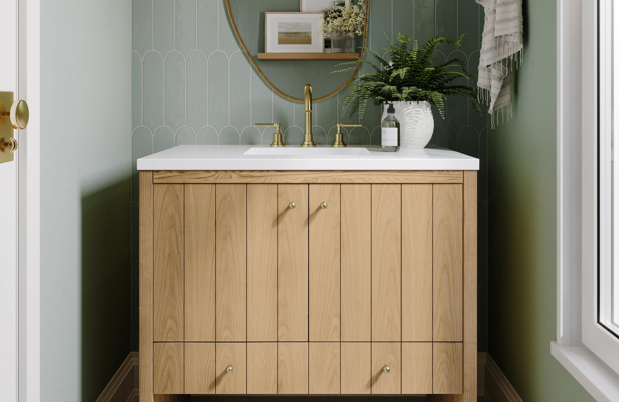 Compact bathroom with a mid-tone wood vanity and oval mirror, paired with brass fixtures and light green scalloped tile for a calm and earthy design.