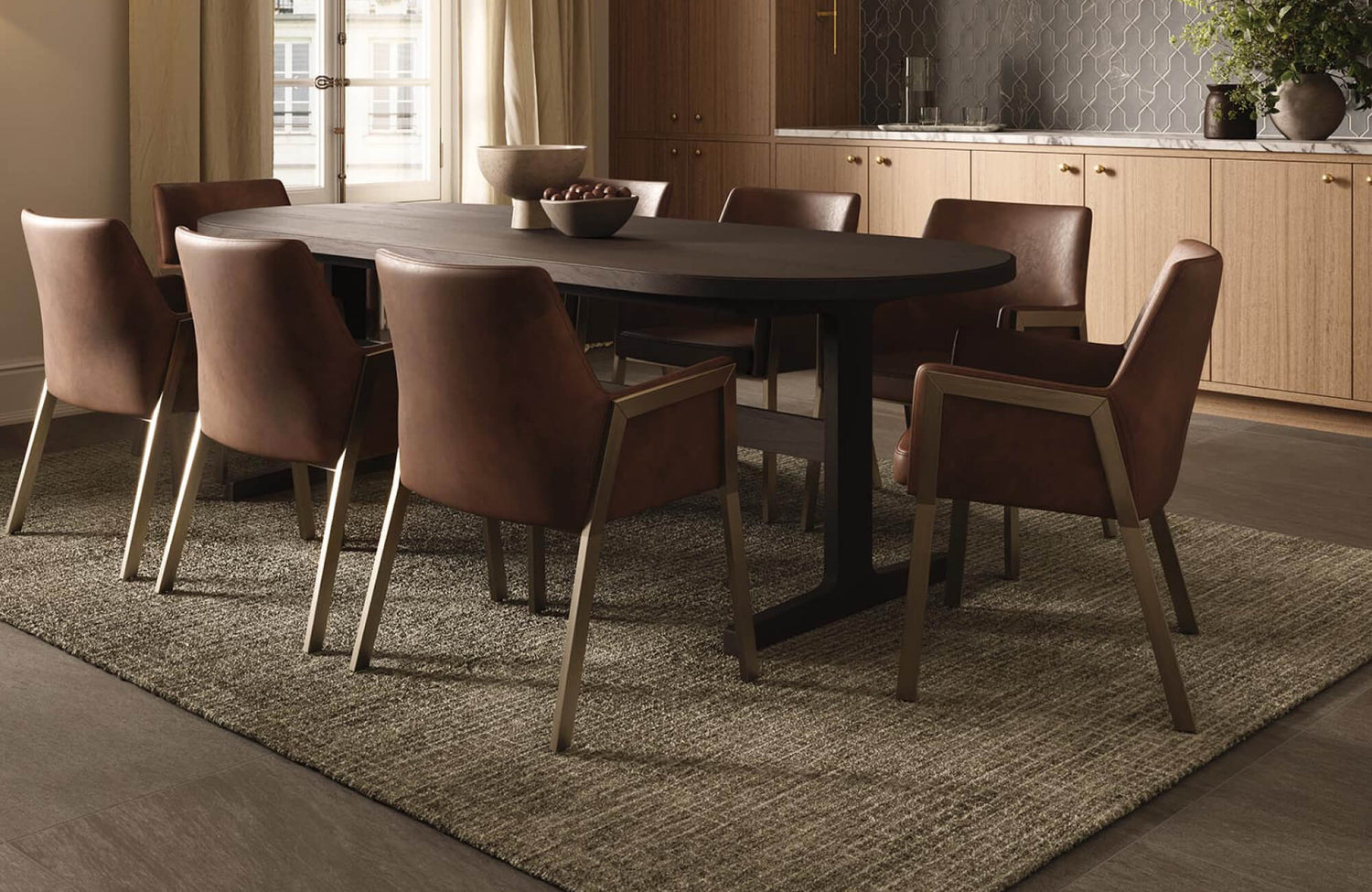 Brown upholstered dining chairs arranged around a dark table, creating a grounded and cohesive seating arrangement.