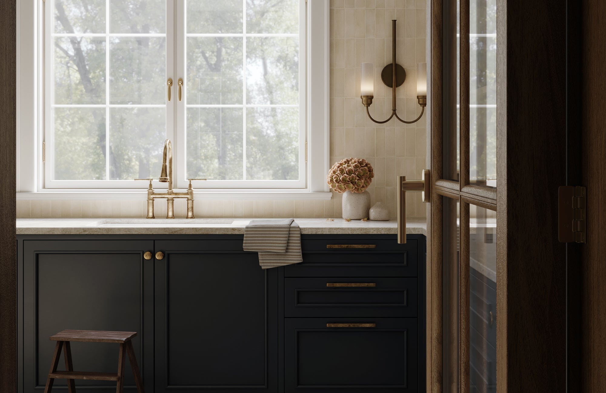 Two-arm wall sconce with cylindrical glass shades adds symmetry and elegance above a farmhouse-style kitchen sink.