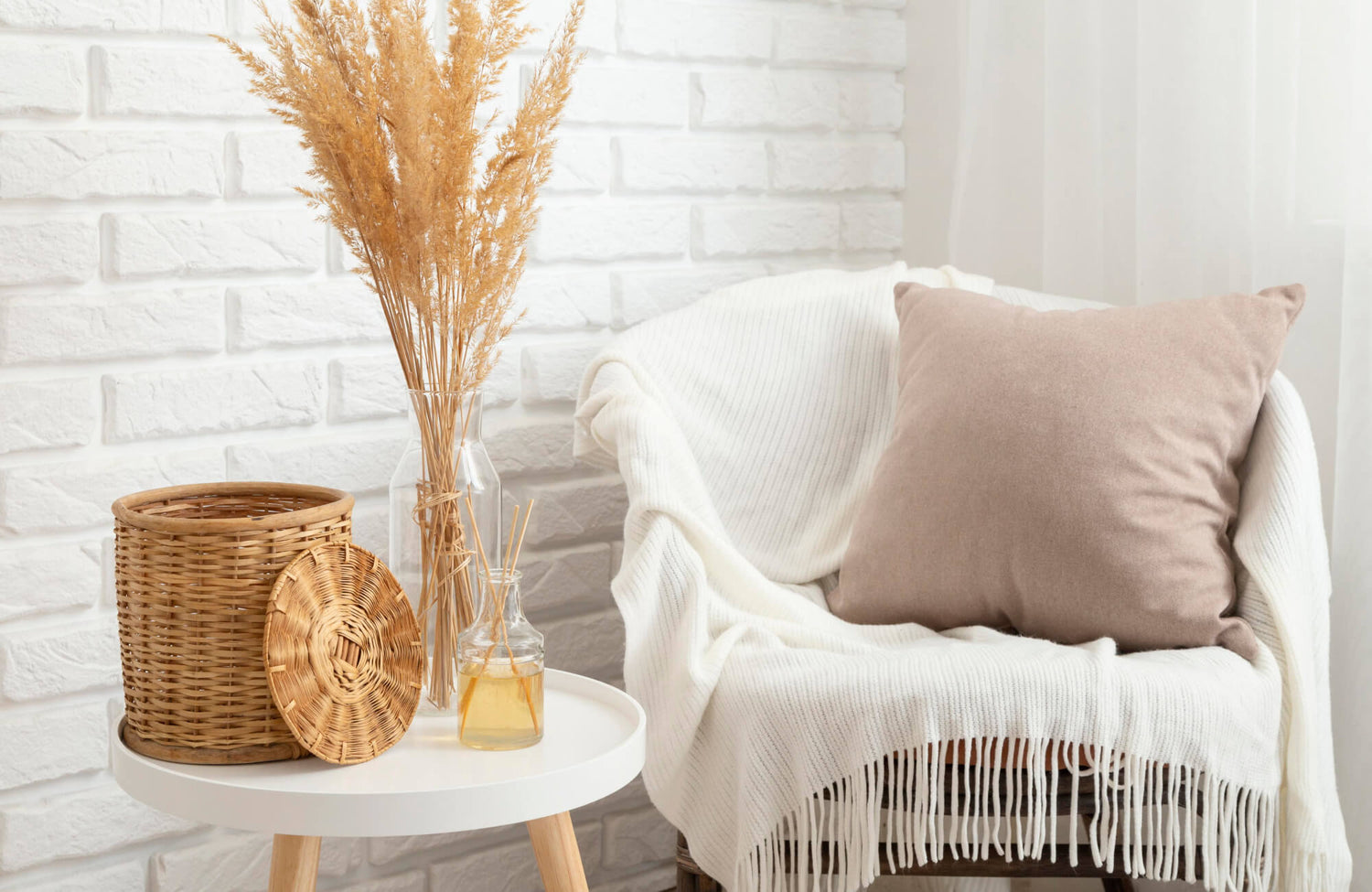 Throw pillow in a small space styled on a cozy armchair with a soft neutral cushion, paired with a textured throw blanket, wicker accents, and dried botanical decor for a warm, space-efficient corner setting.