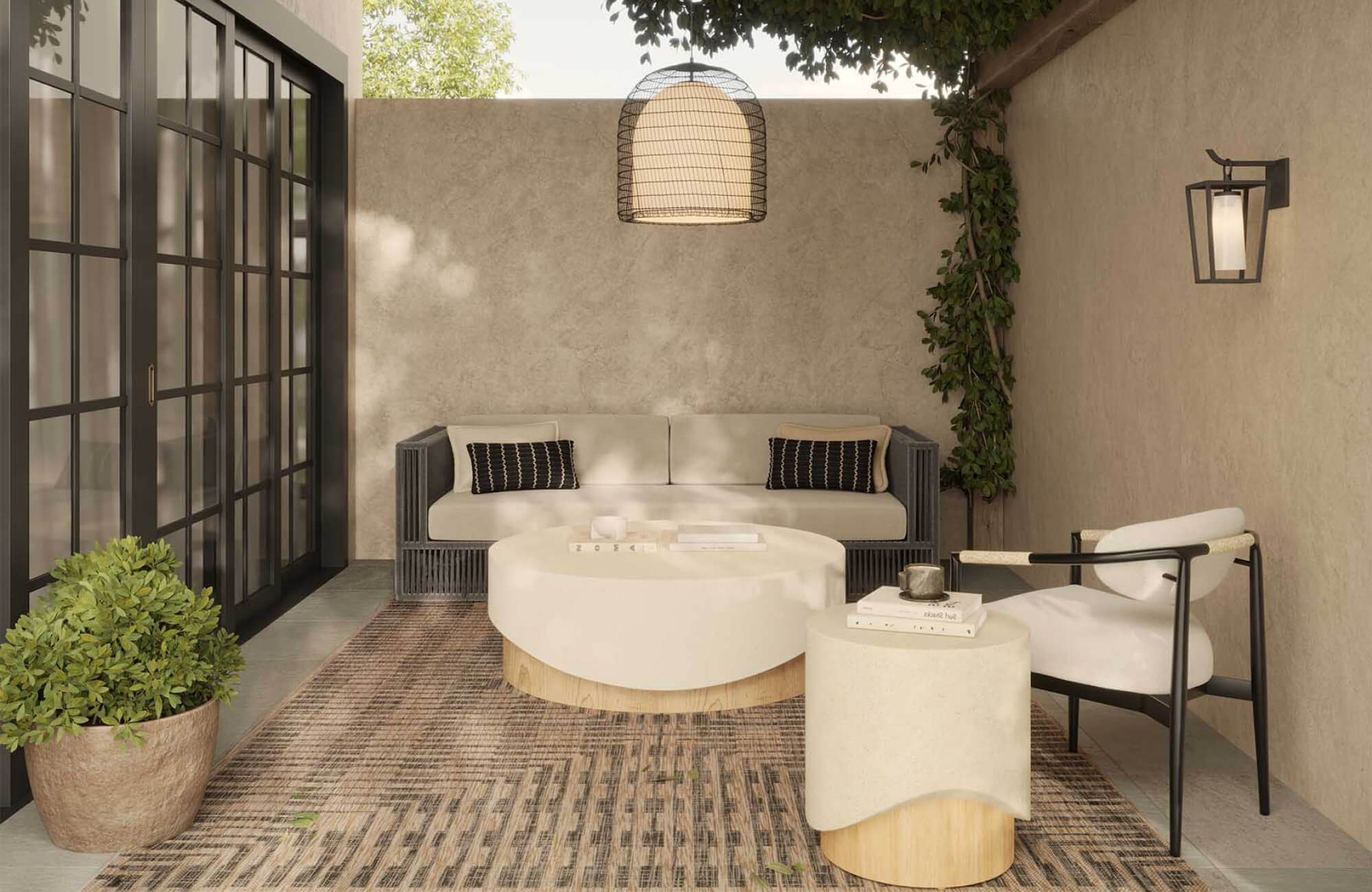Serene patio with stone look tile flooring, cushioned sofa, lumbar pillows, armchair, pendant light, sconce, round coffee table, side table, and textured area rug.