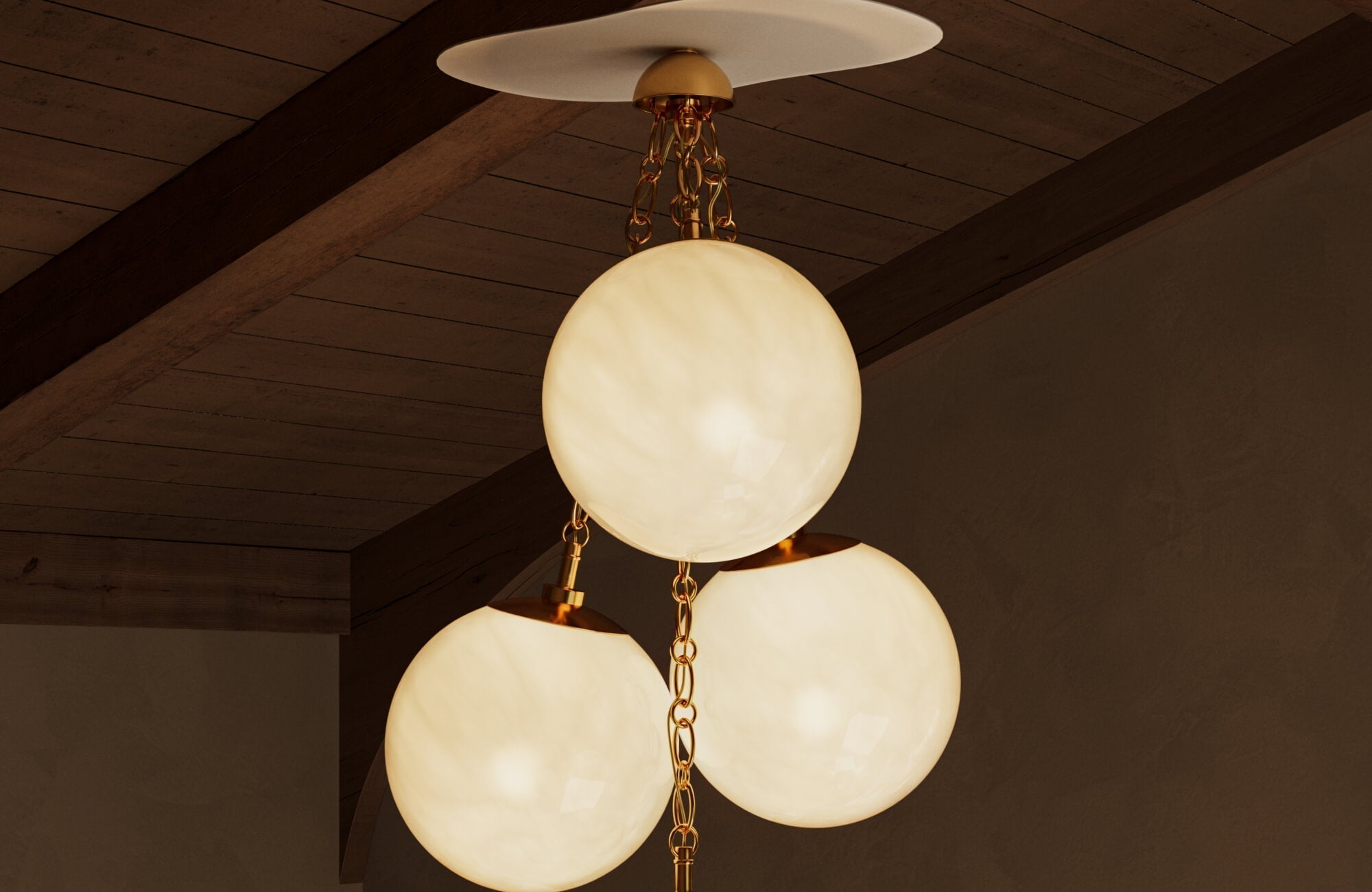 A modern ceiling light featuring three softly glowing glass globes suspended from a warm brass chain beneath a wood-paneled ceiling.