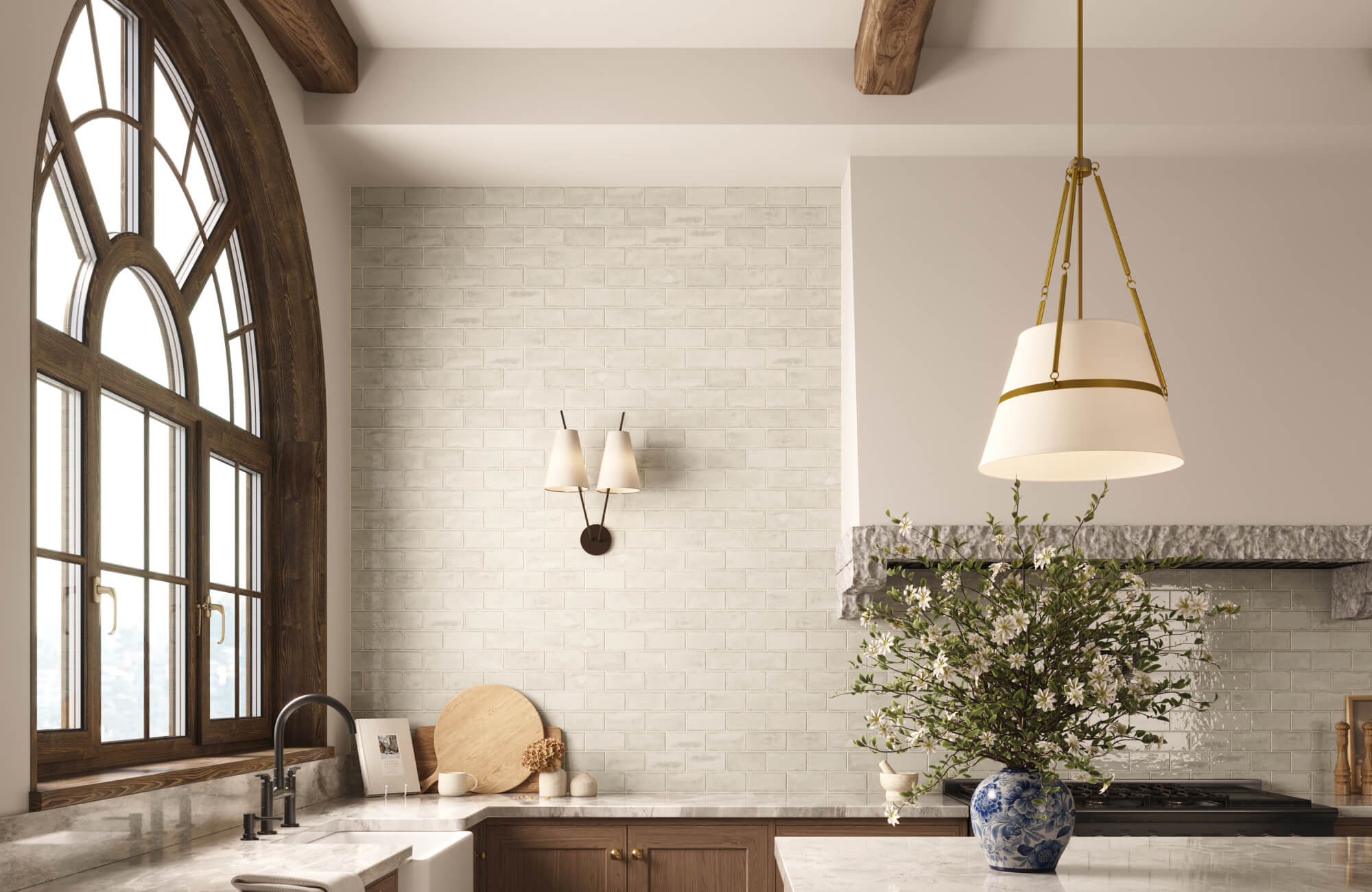 Large cone-shaped pendant illuminating the kitchen island beneath wood beams in a warm, neutral-toned space.