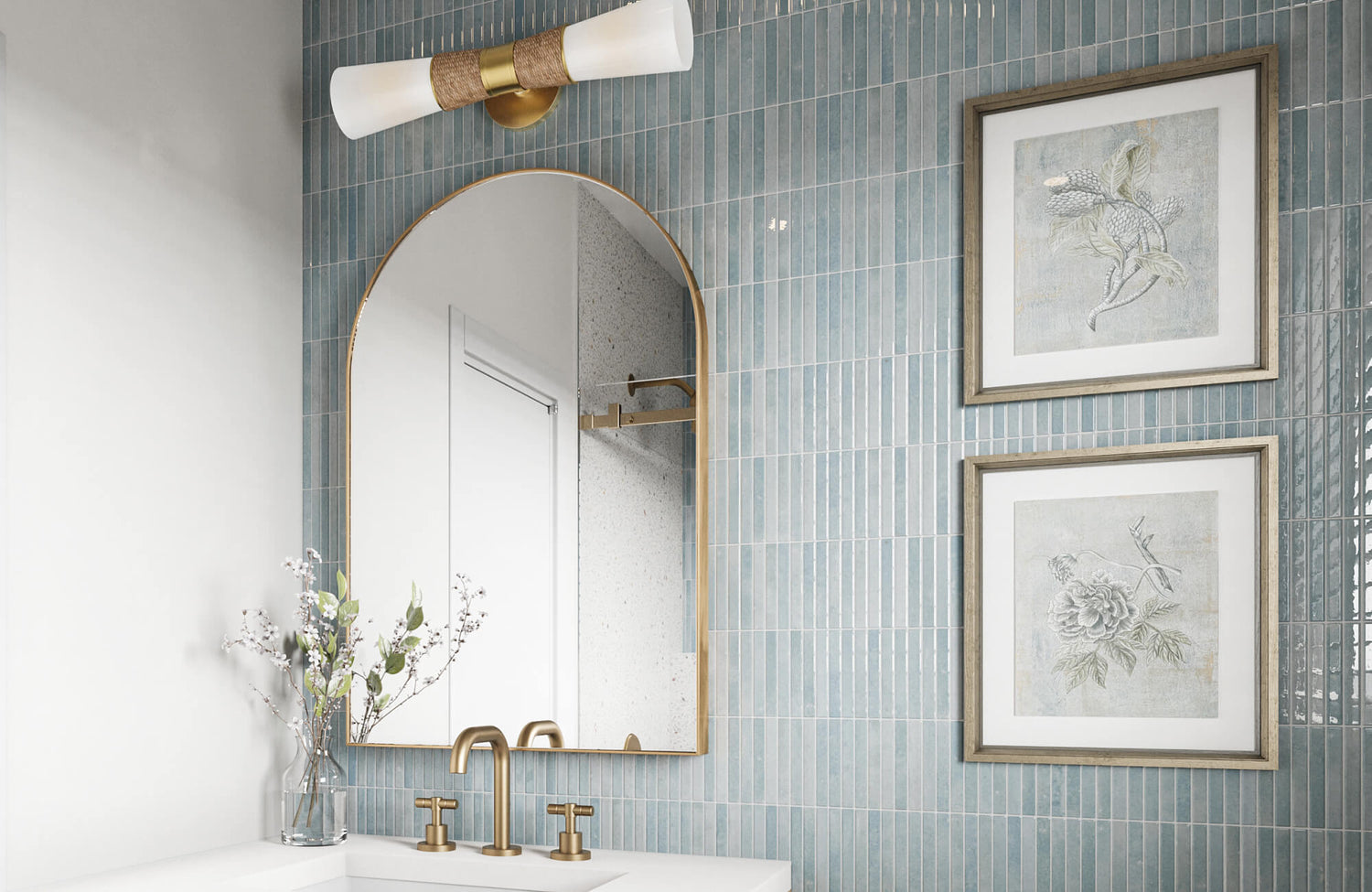 Glossy vertical blue ceramic tiles create a serene backsplash in this modern vanity, paired with brass fixtures and an arched mirror.