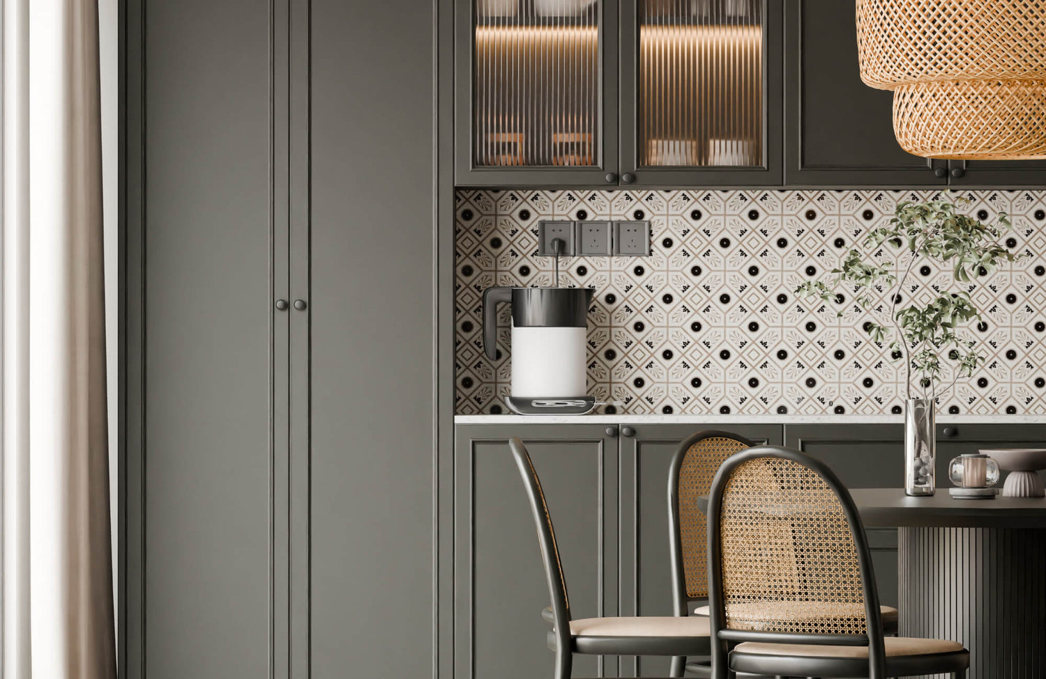 Modern kitchen with dark green cabinets, patterned tile backsplash, rattan dining chairs, and warm ambient lighting.