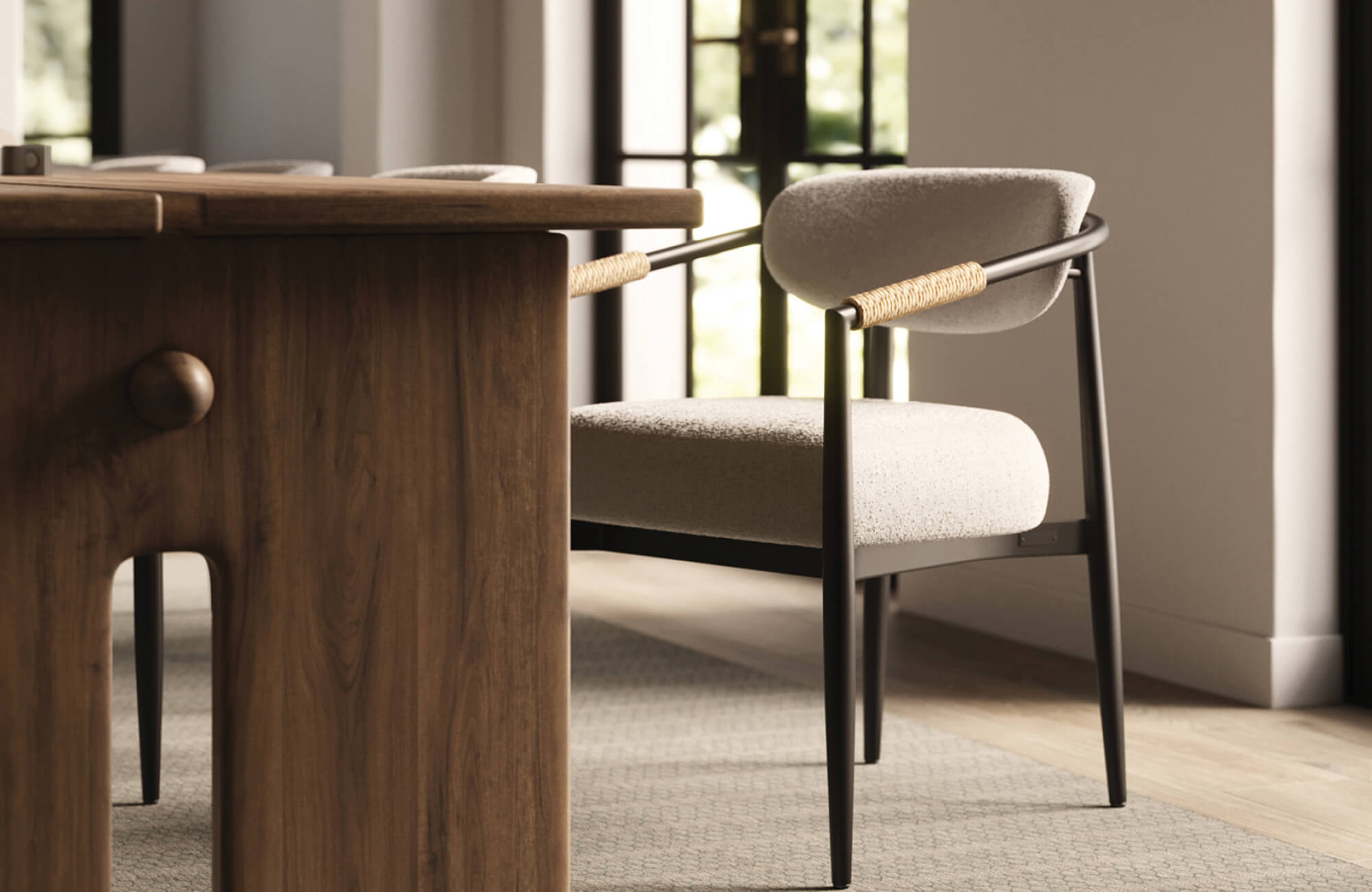 Light beige upholstered dining chair with black frame beside a warm wood table, creating a soft, balanced dining atmosphere.