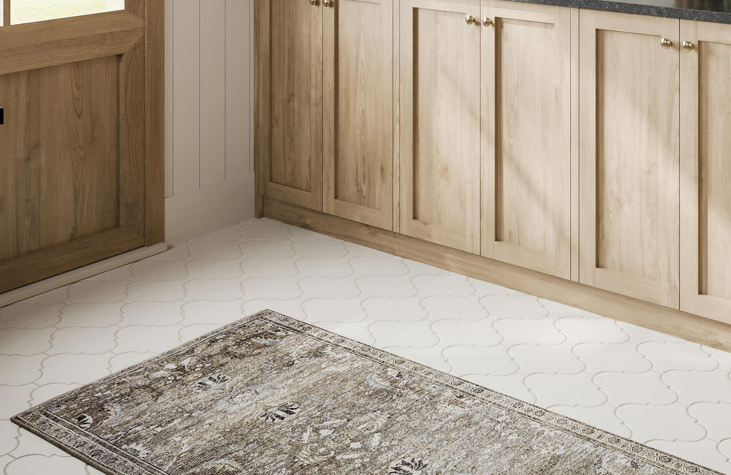 Elegant white arabesque tiles paired with a vintage-style rug, adding charm and warmth to the mudroom entry.