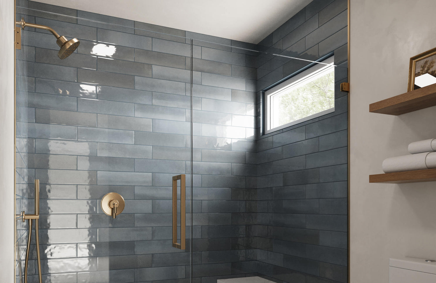 Glossy steel blue ceramic tiles paired with brass fixtures and light oak shelving create a modern, spa-like shower with rich contrast