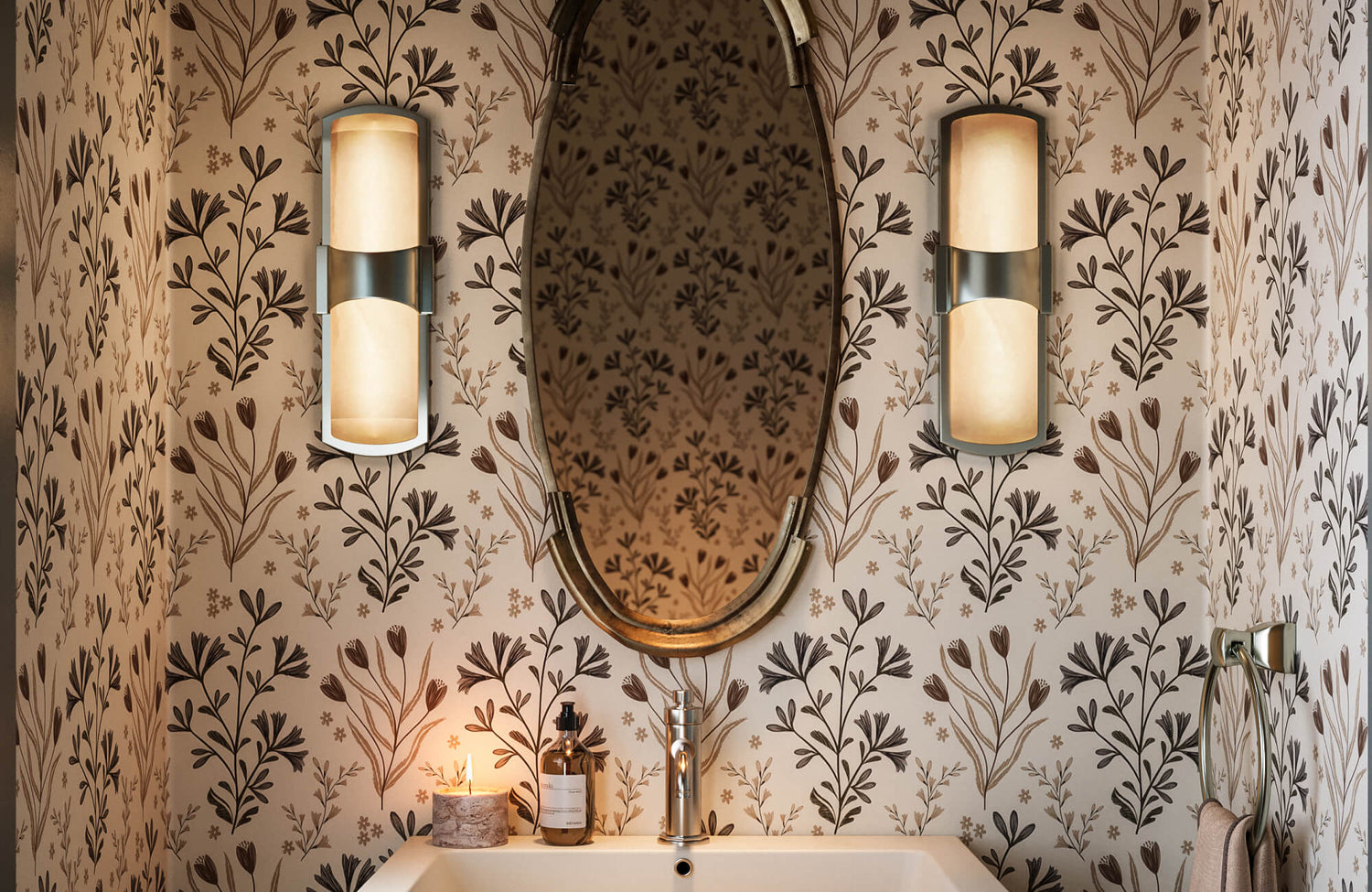 Floral-patterned wallpaper frames a modern sink setup, accented by brushed metal fixtures and symmetrical wall lighting.