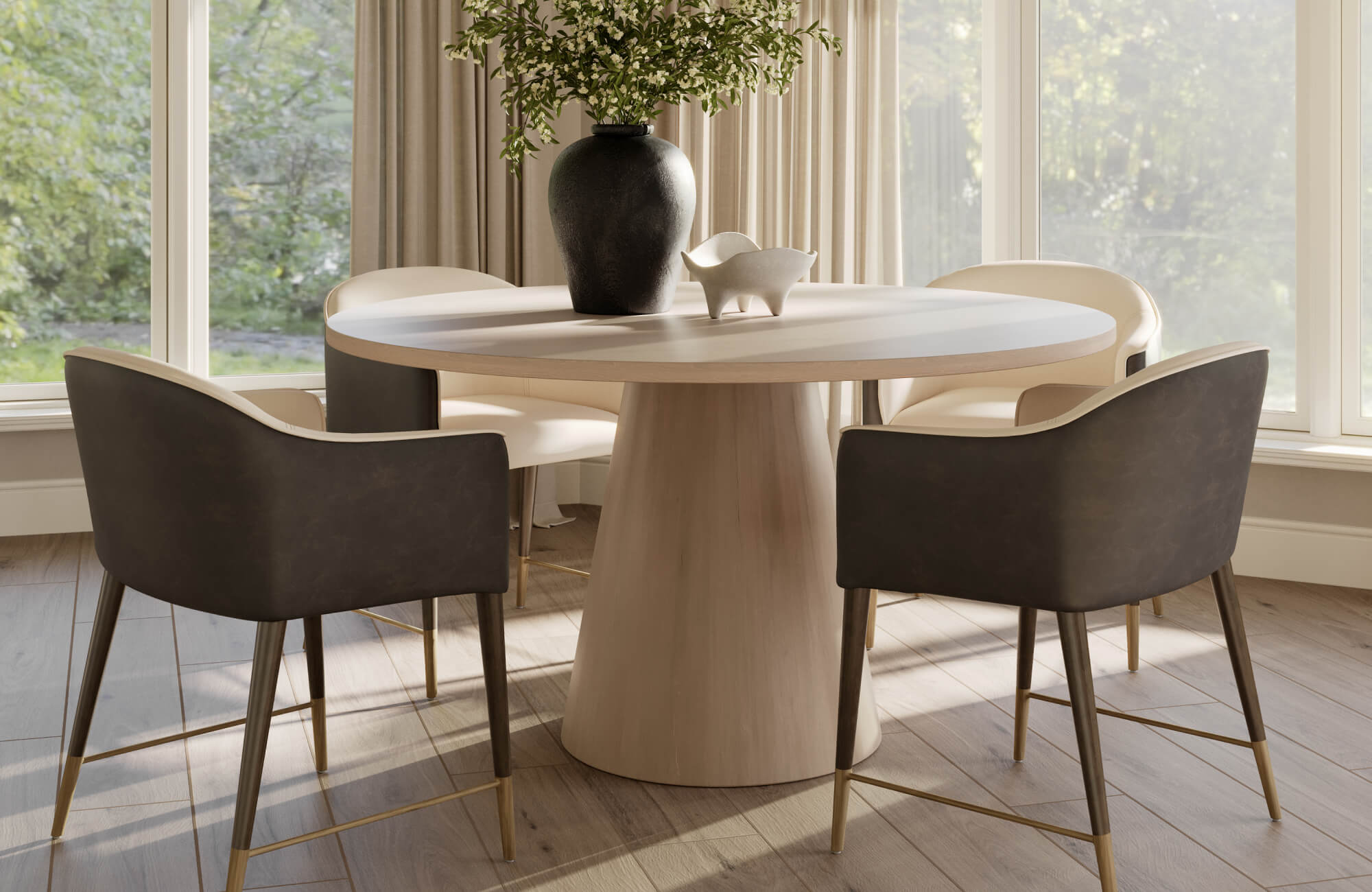 Sculpted round wood table with modern black vase and cream-accent chairs on warm-toned wood look tile flooring.