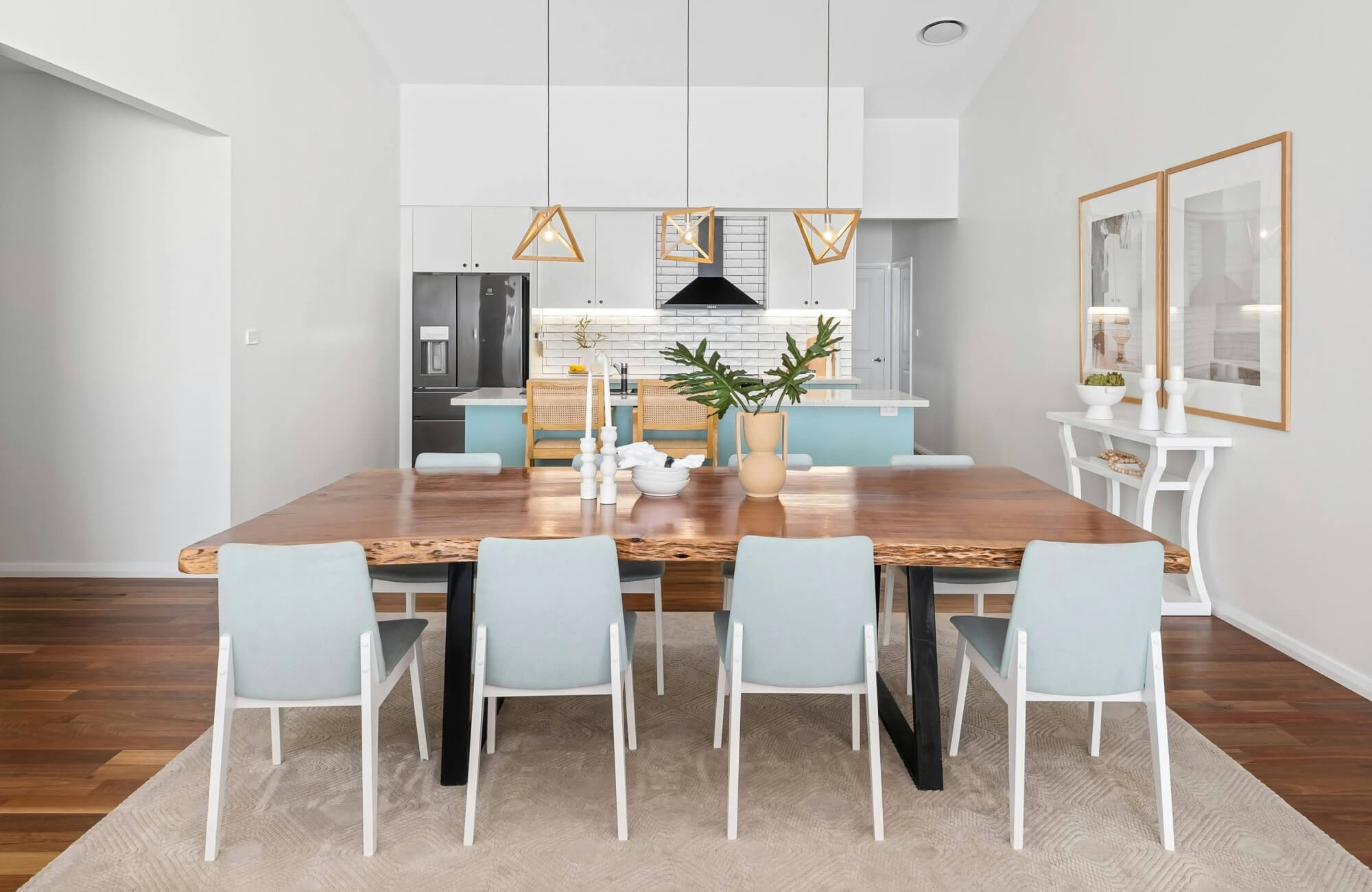 Neutral beige dining room rug under a live-edge wooden table, adding texture and warmth to a modern space.