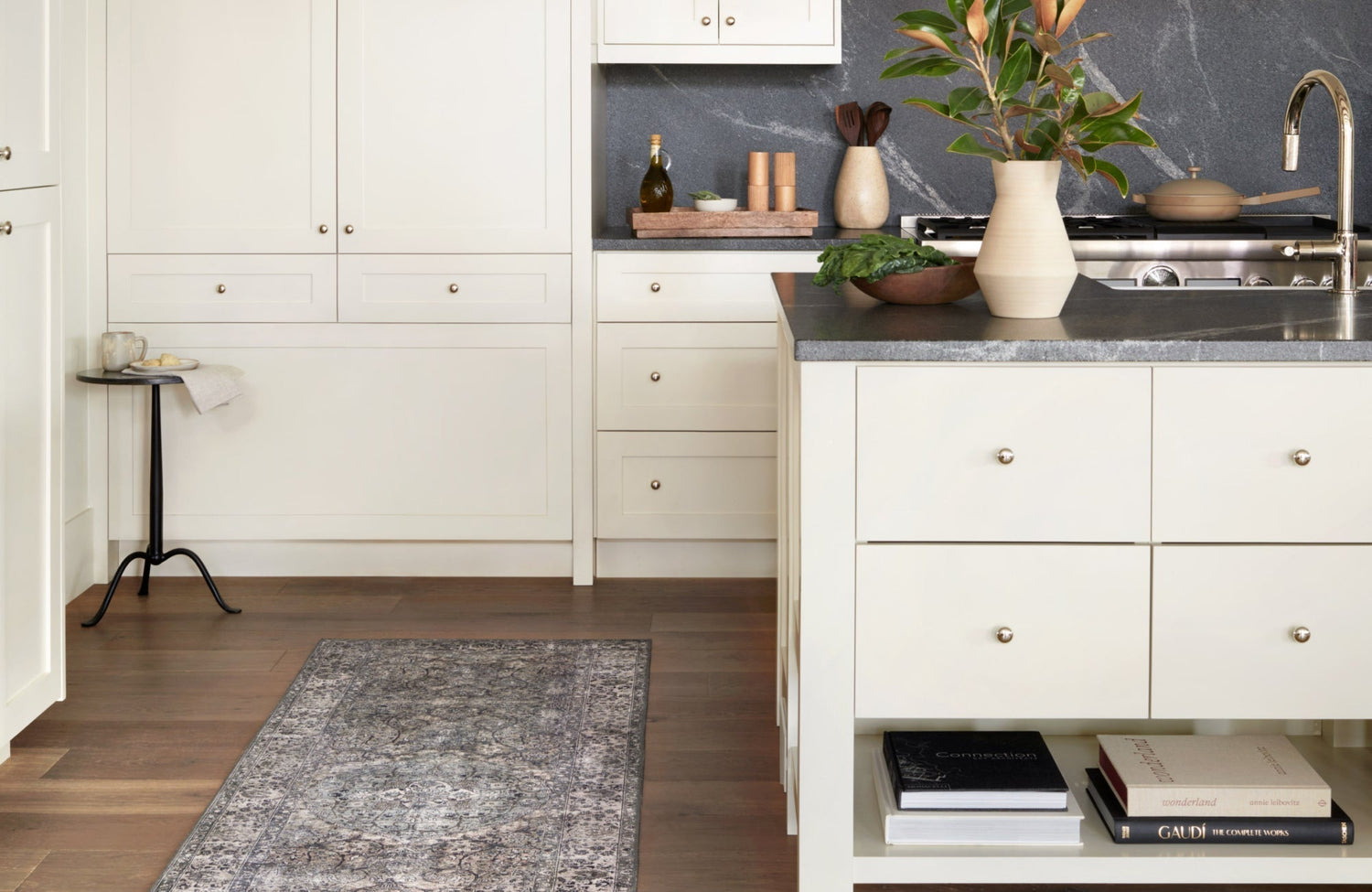 Neutral vintage-style rug runner placed in a bright, modern kitchen with white cabinetry and wood floors