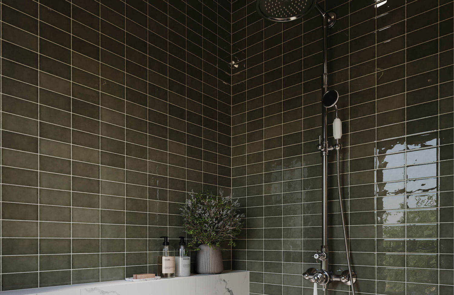 Glossy green bathroom tile in a stacked layout creates a rich, spa-like backdrop, paired with sleek fixtures and a clean ledge for a modern shower design.
