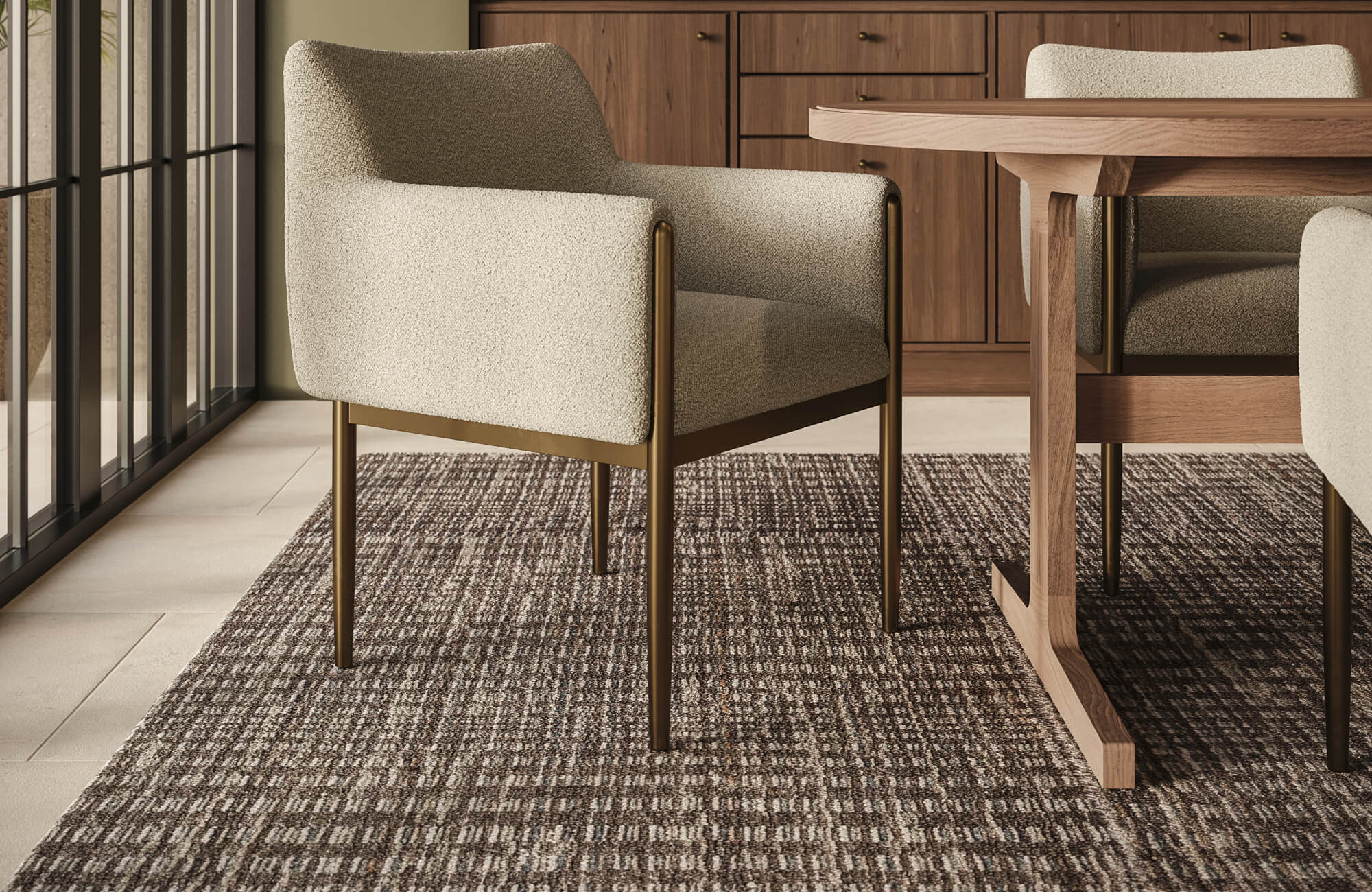 A woven wool rug with tonal brown variation extends beneath the dining table, bringing depth, comfort, and natural texture to the interior.