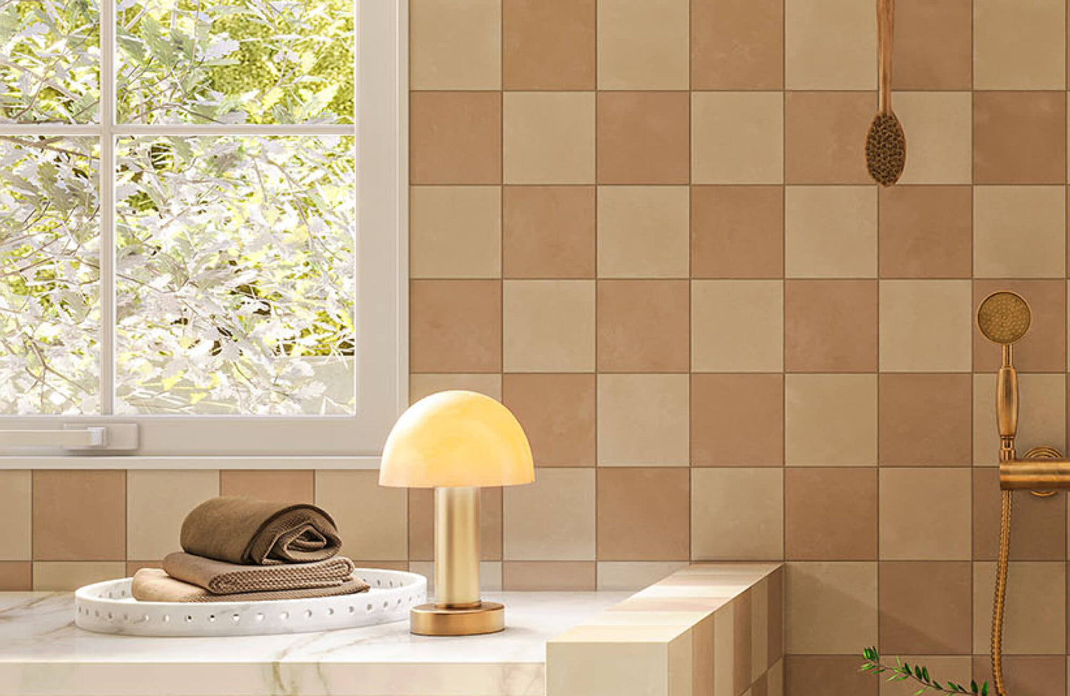Washroom tub ledge styled with a white decorative tray holding folded towels, placed beside a small lamp for a warm, spa-like display.