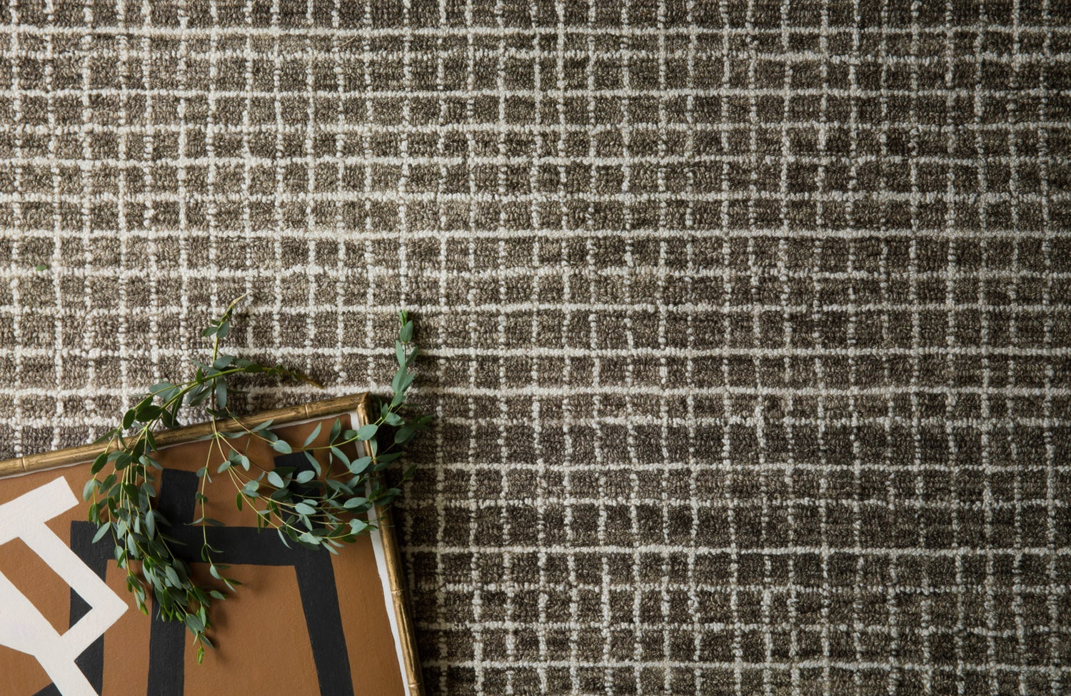 Top-down view of a wool-nylon blend rug with a grid-like pattern, showing detailed texture and balanced tone.