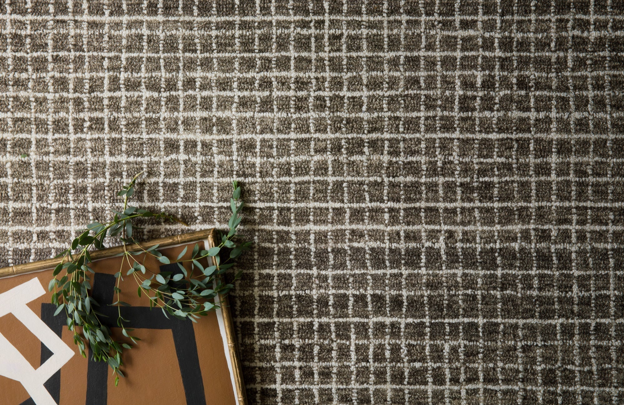 Top-down view of a wool-nylon blend rug with a grid-like pattern, showing detailed texture and balanced tone.