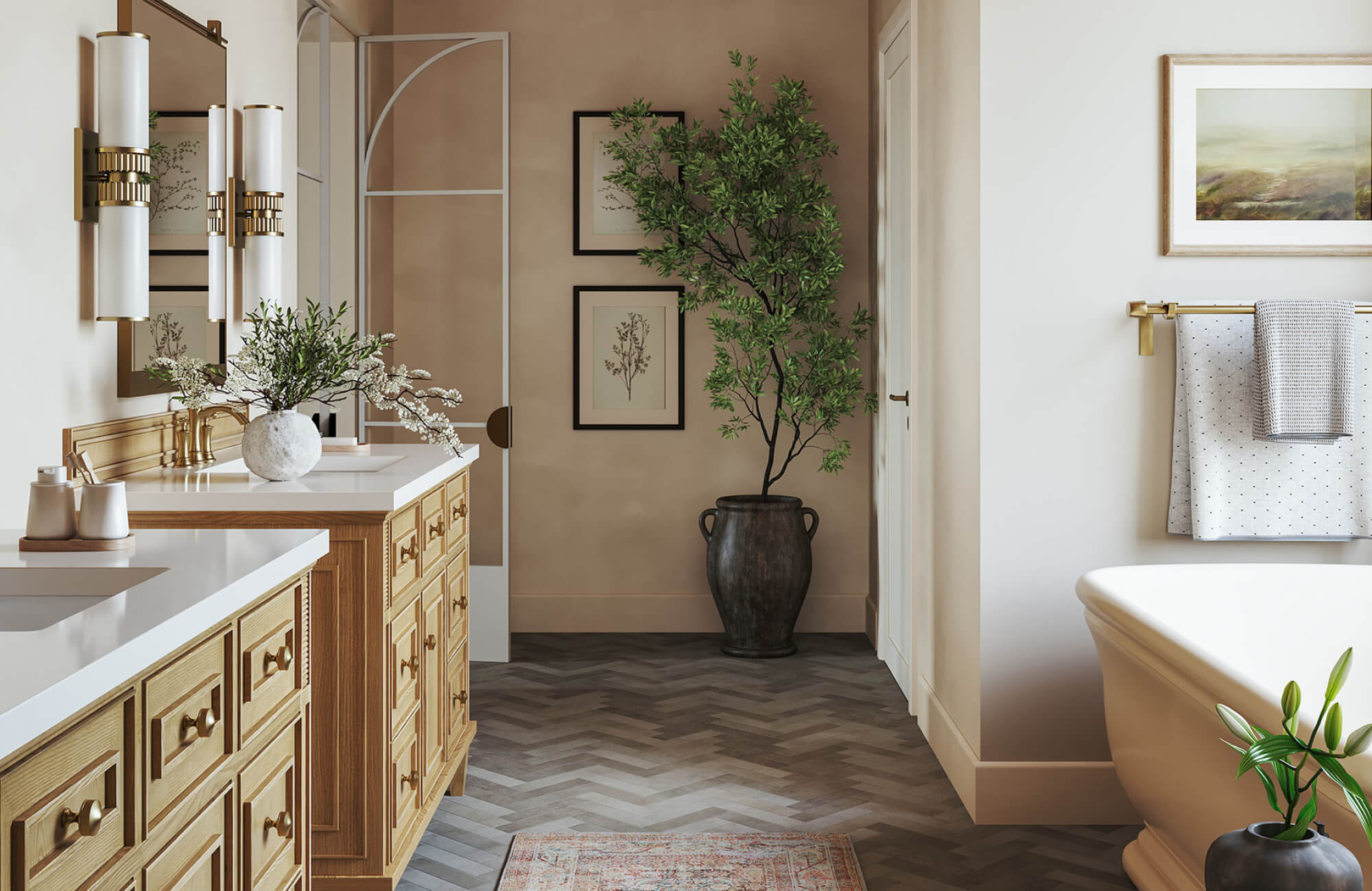 Spacious bathroom with light wood double vanities, brass fixtures, herringbone flooring, and framed botanical wall art beside a freestanding bathtub beneath exposed wood ceiling beams.