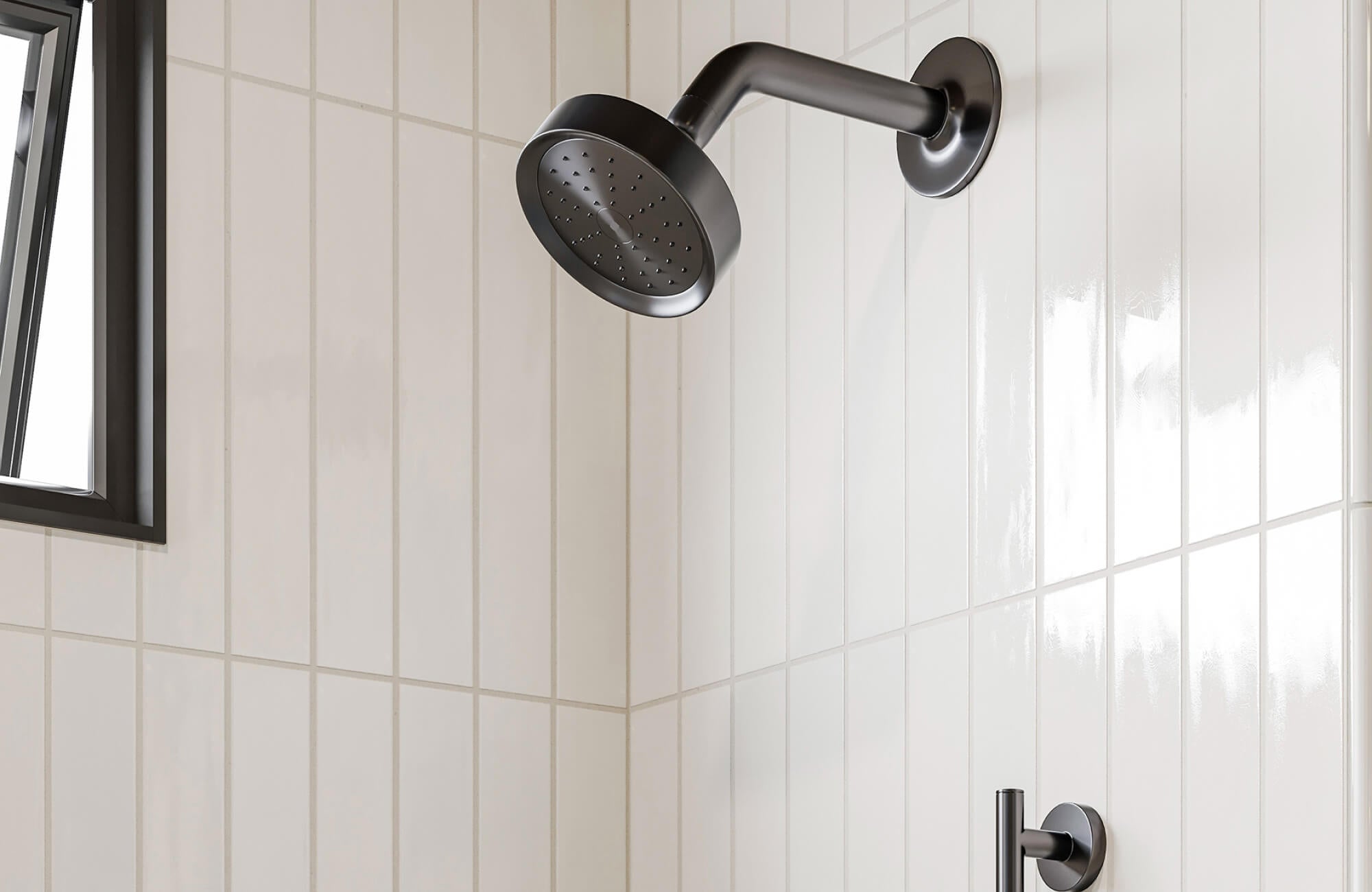 Modern shower detail with dark fixtures against sleek white tiles, showing how finish choices impact both style and easy upkeep in wet spaces.
