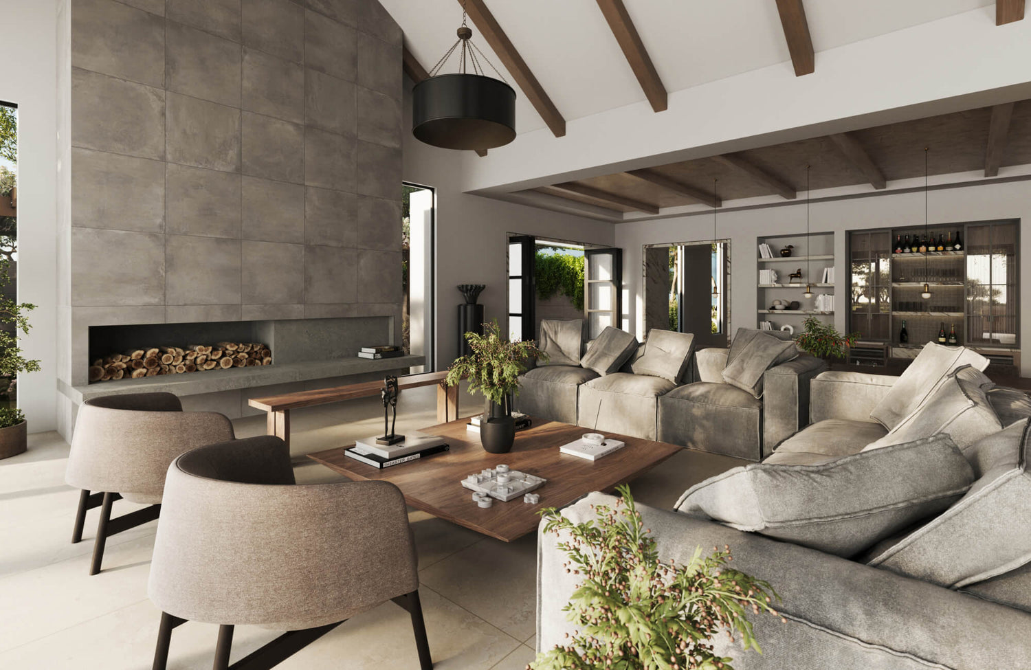 Modern living room with neutral sofa and oversized decorative pillows, wood beams, stone fireplace, and warm natural lighting.