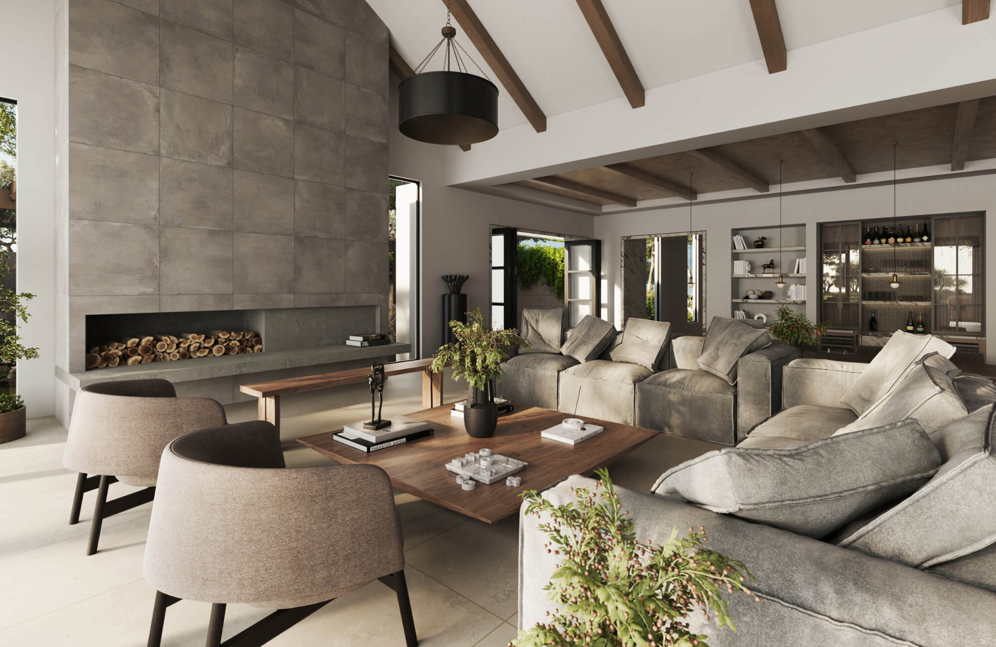 Modern living room with neutral sofa and oversized decorative pillows, wood beams, stone fireplace, and warm natural lighting.