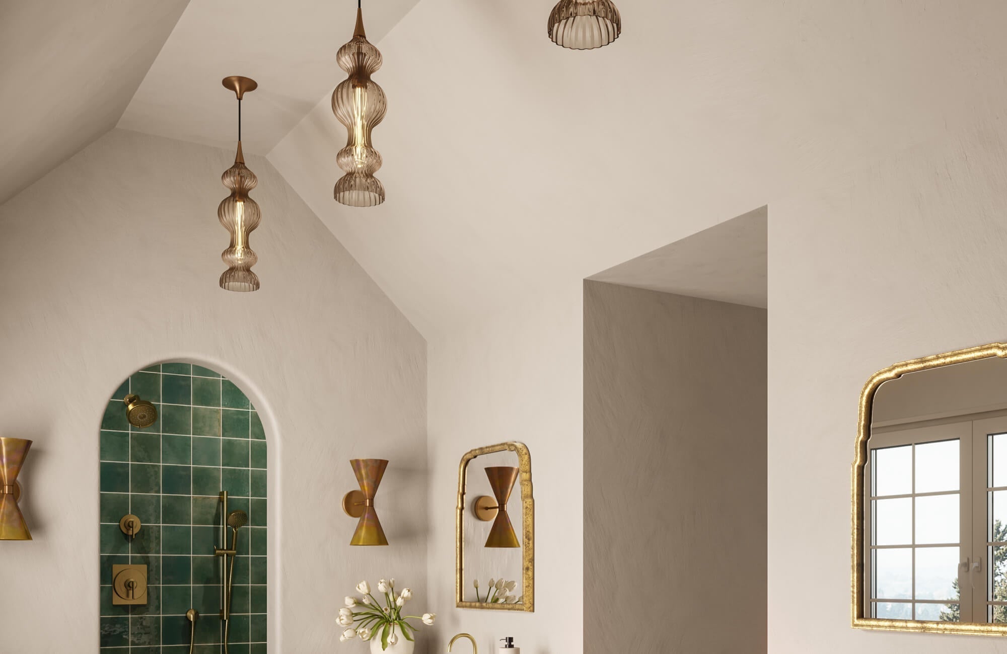 A warm, elegant bathroom showcases sculptural pendant bathroom lights hanging from the vaulted ceiling and paired brass cone-shaped wall sconces flanking the mirror, creating layered, atmospheric illumination throughout the space.