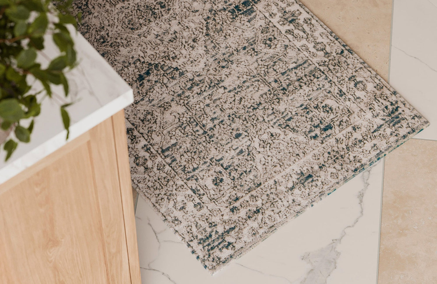 A textured 3x5 rug placed in a bright kitchen corner on marble tile, adding warmth and comfort underfoot.