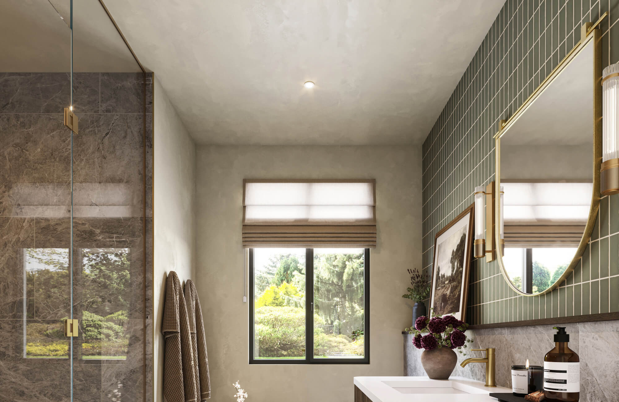Modern bathroom mirror with a slim gold frame reflects natural light against green tiled walls, creating a refined balance of elegance and warmth in the vanity space.