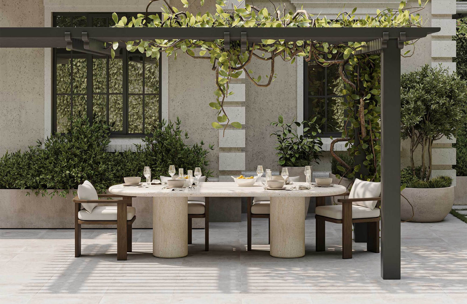 Elegant outdoor dining area with stone table, wood chairs, and pergola covered in greenery, creating a refined garden setting.