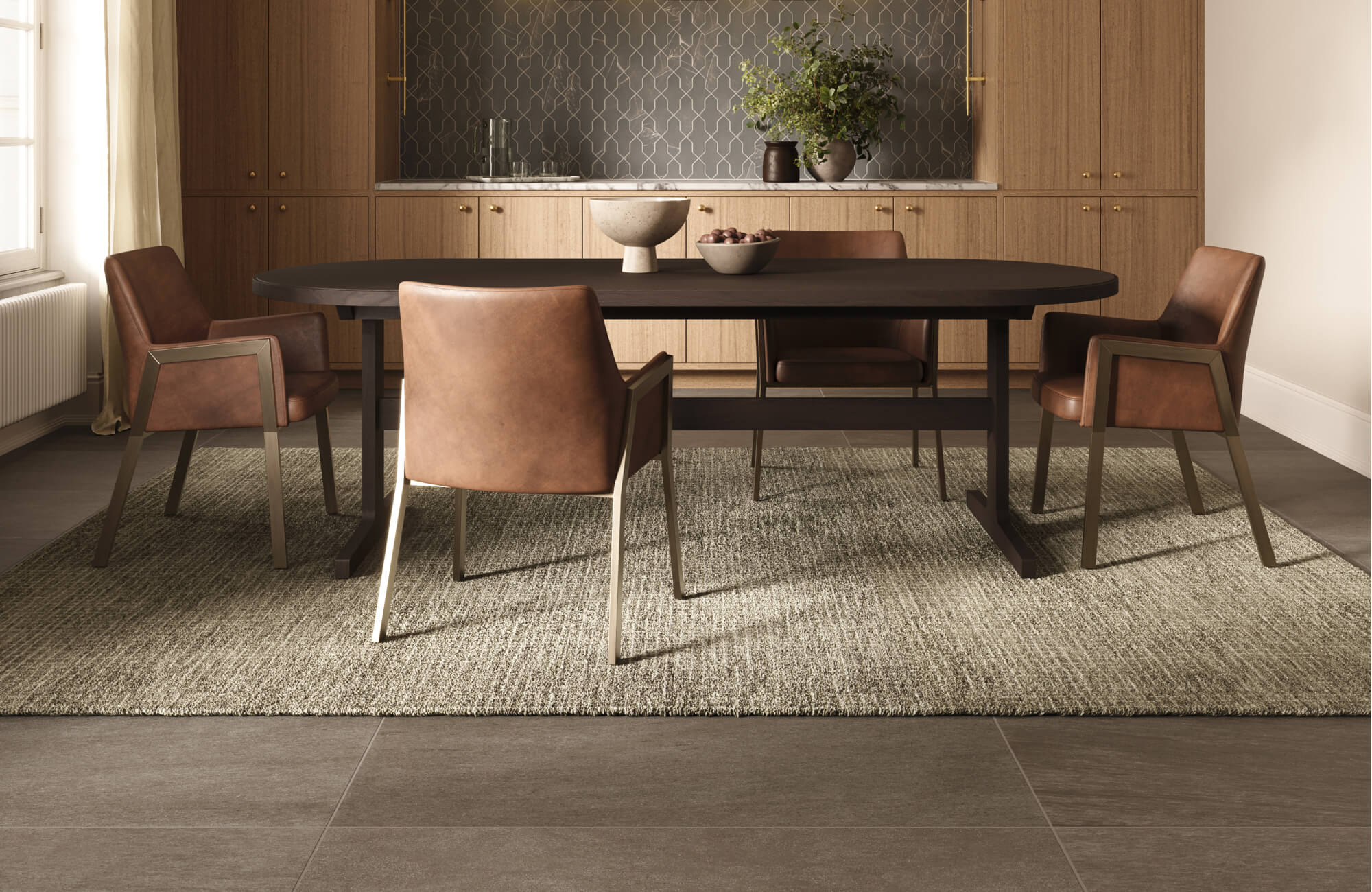 Sophisticated dining room with a dark oval table, brown leather chairs, and a textured rug over large gray floor tiles.