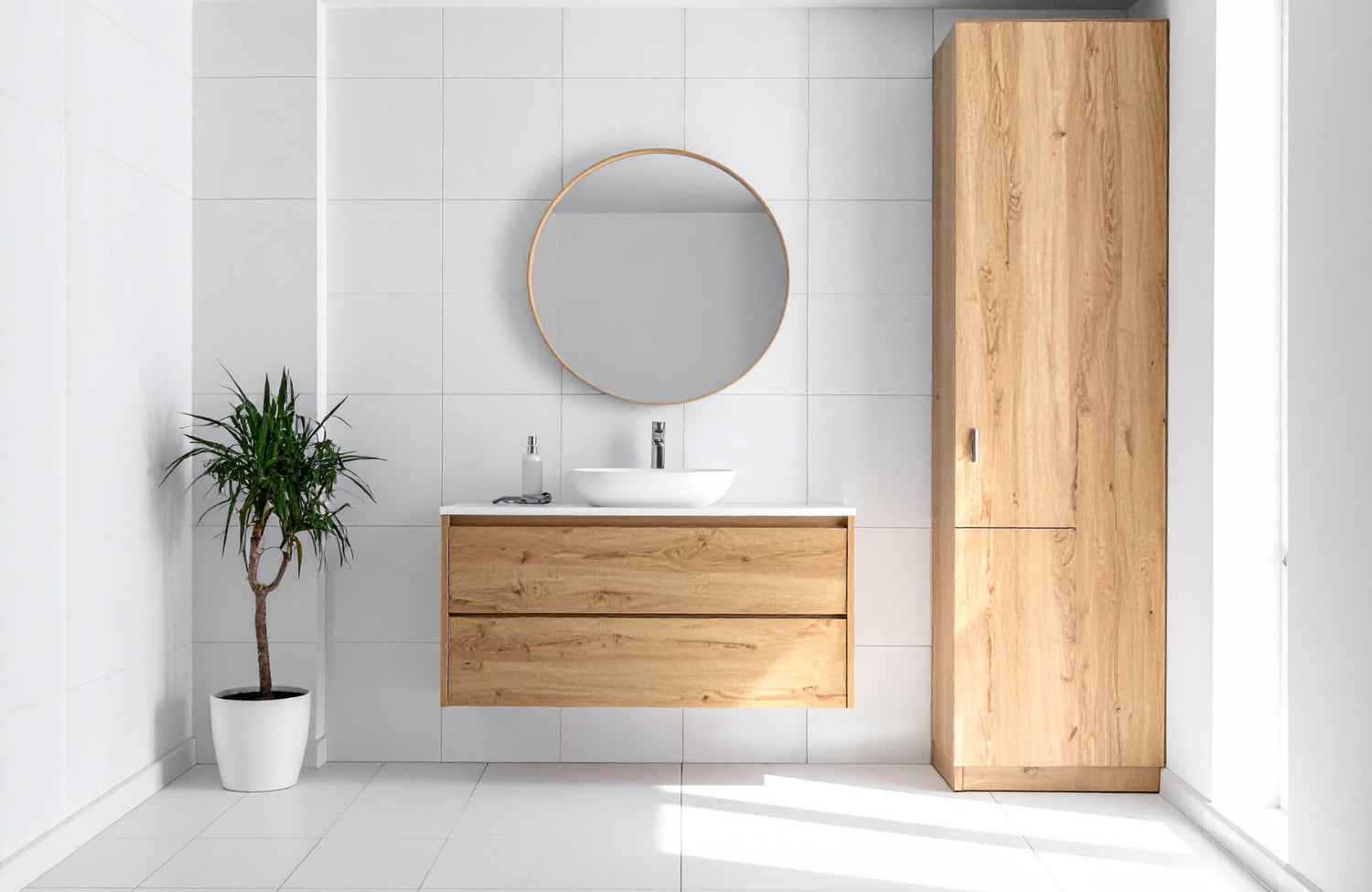 Modern bathroom with a light oak floating vanity, tall oak cabinet, round mirror, and white tile walls.