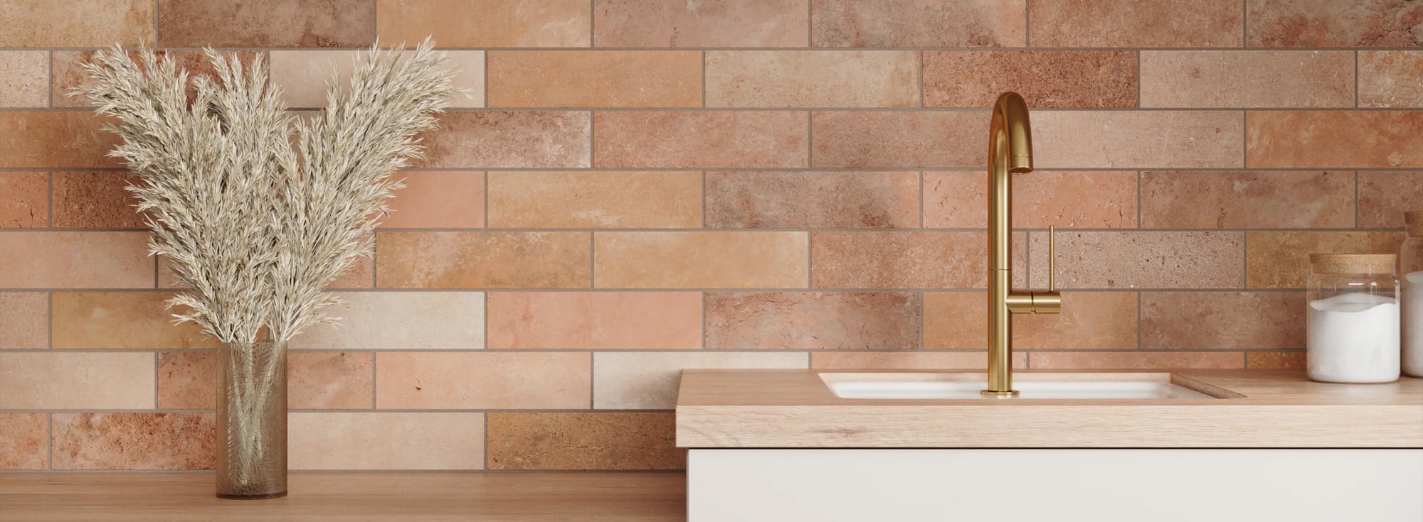 Warm-toned brick look tile adds rustic charm to a minimalist bathroom, complemented by a chic gold faucet
