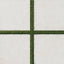 Bowden Canvas 24x24 2CM Grip tile in a light cream tone, paired with vibrant green turf for a modern outdoor aesthetic.