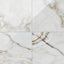 Astrid 24x24 polished porcelain tile in Pearl, highlighting a glossy finish with soft white and gold veining patterns.