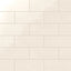 Soft cream 4x10-inch ceramic subway tiles with a glossy finish, arranged in a staggered brick pattern