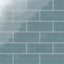 Vibrant ocean blue 4x10-inch glossy ceramic subway tiles arranged in a staggered brick pattern for a bold, modern look
