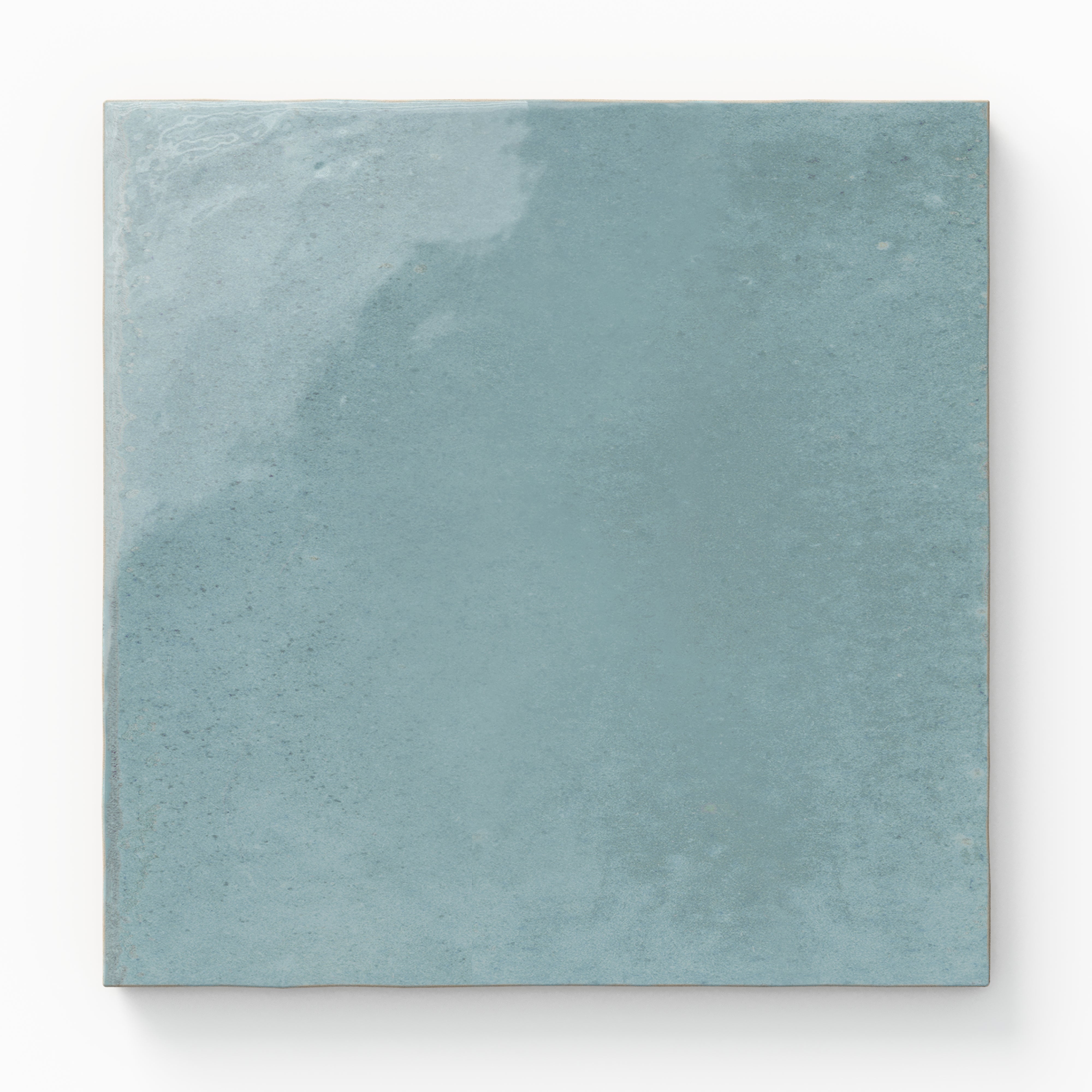 Square porcelain tile in a smooth light blue finish with natural tone variation.