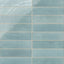 Subway porcelain tiles in soft blue with rustic surface variation and a handcrafted feel.