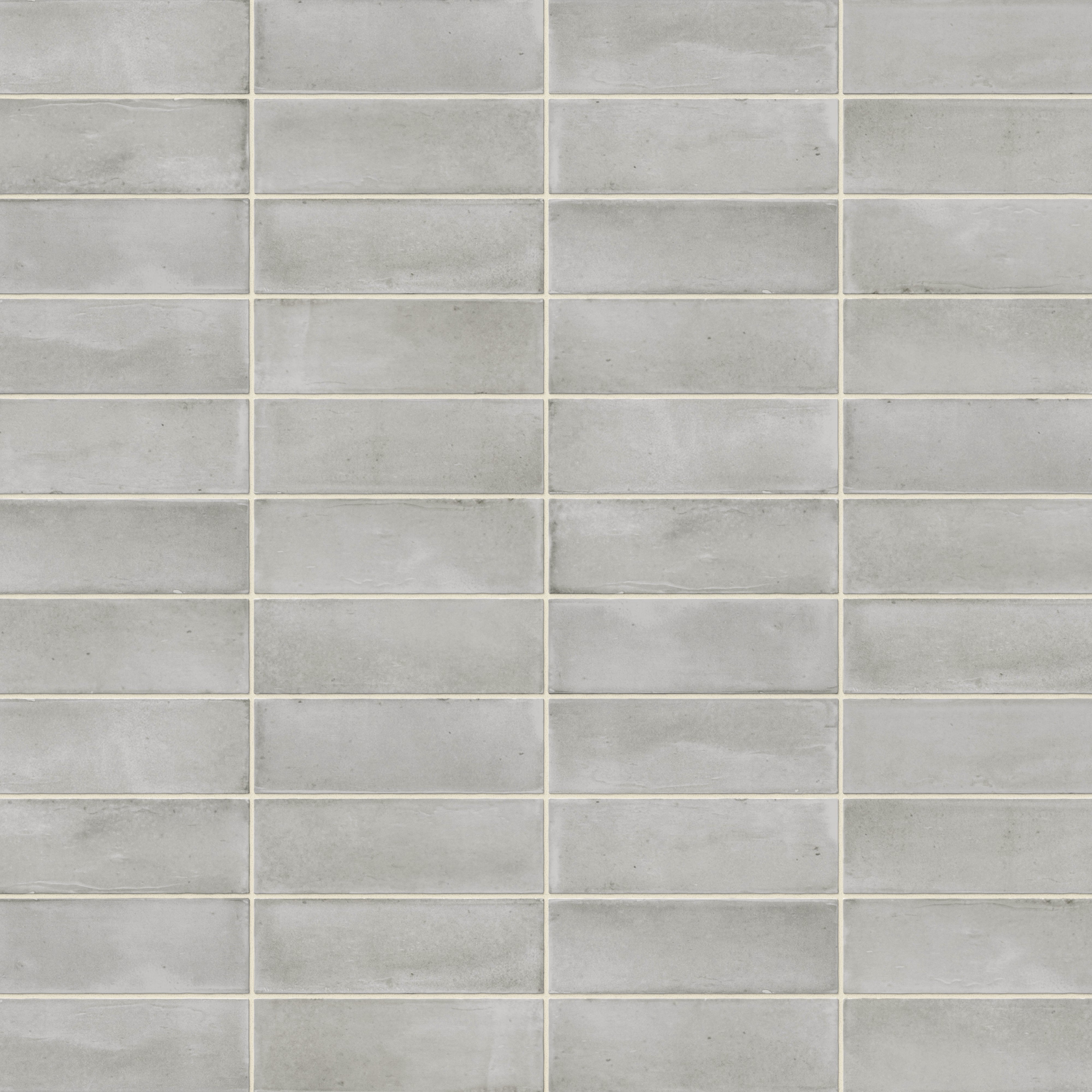A 2x6 porcelain subway tiles in weathered gray, featuring a matte finish, and a clean stacked layout with fine grout lines.