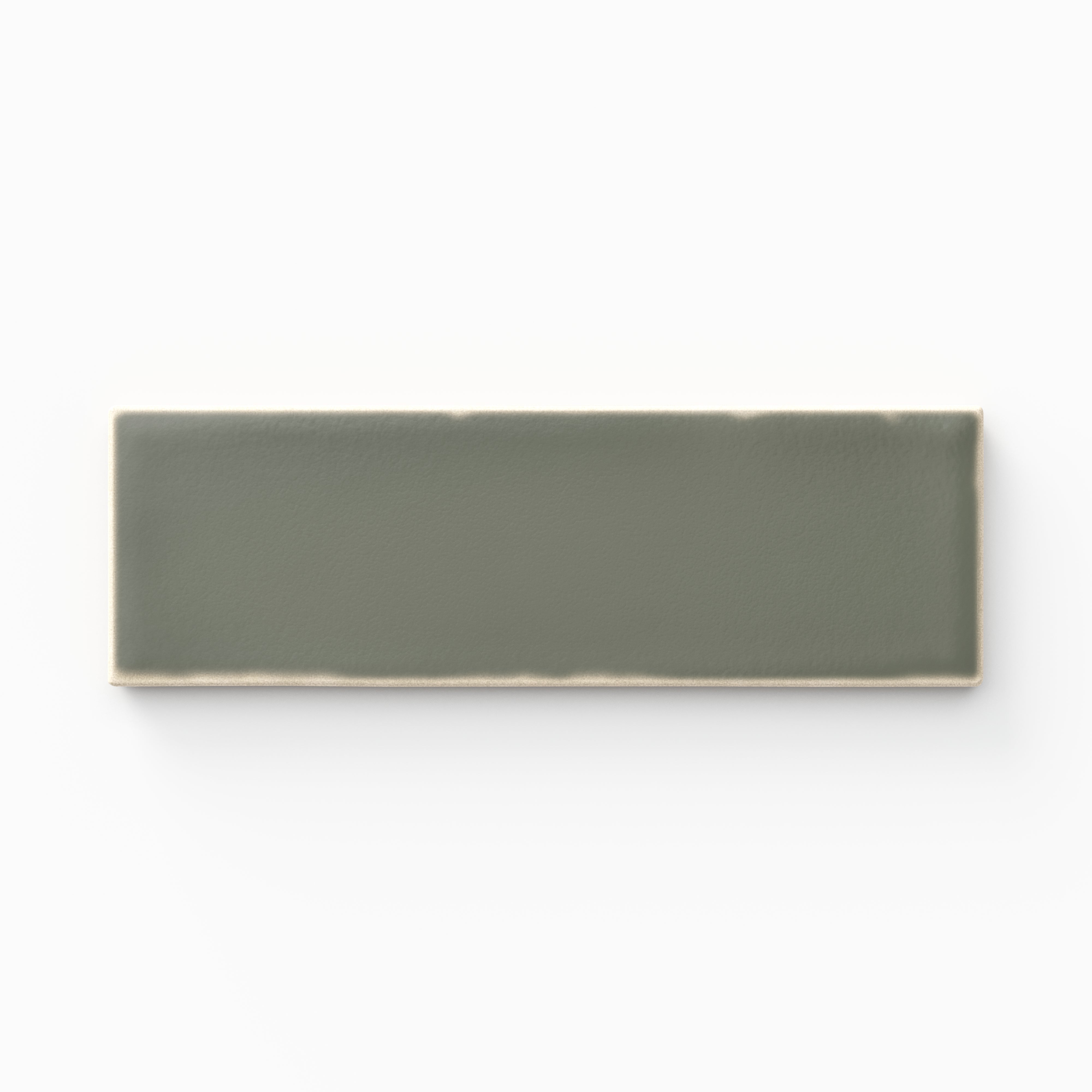 A 1.6x5 ceramic tile in muted green, featuring a matte finish, soft tonal variation, and a clean, flat-edge profile.