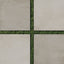 Checkerboard pattern of matte 24x24 concrete tiles in putty and chalk colors with green grass visible between the square gaps.