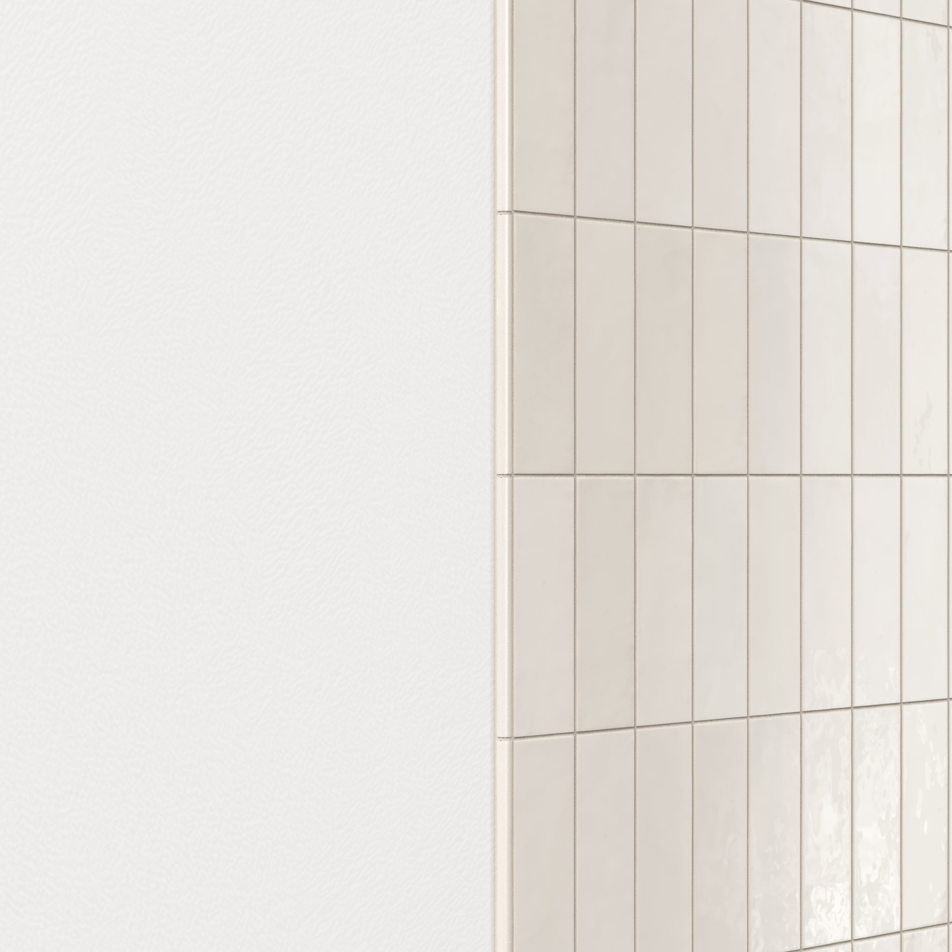 Wall finished with glossy subway tiles in shifting white tones, featuring a rounded tile edge trim for a smooth, polished transition