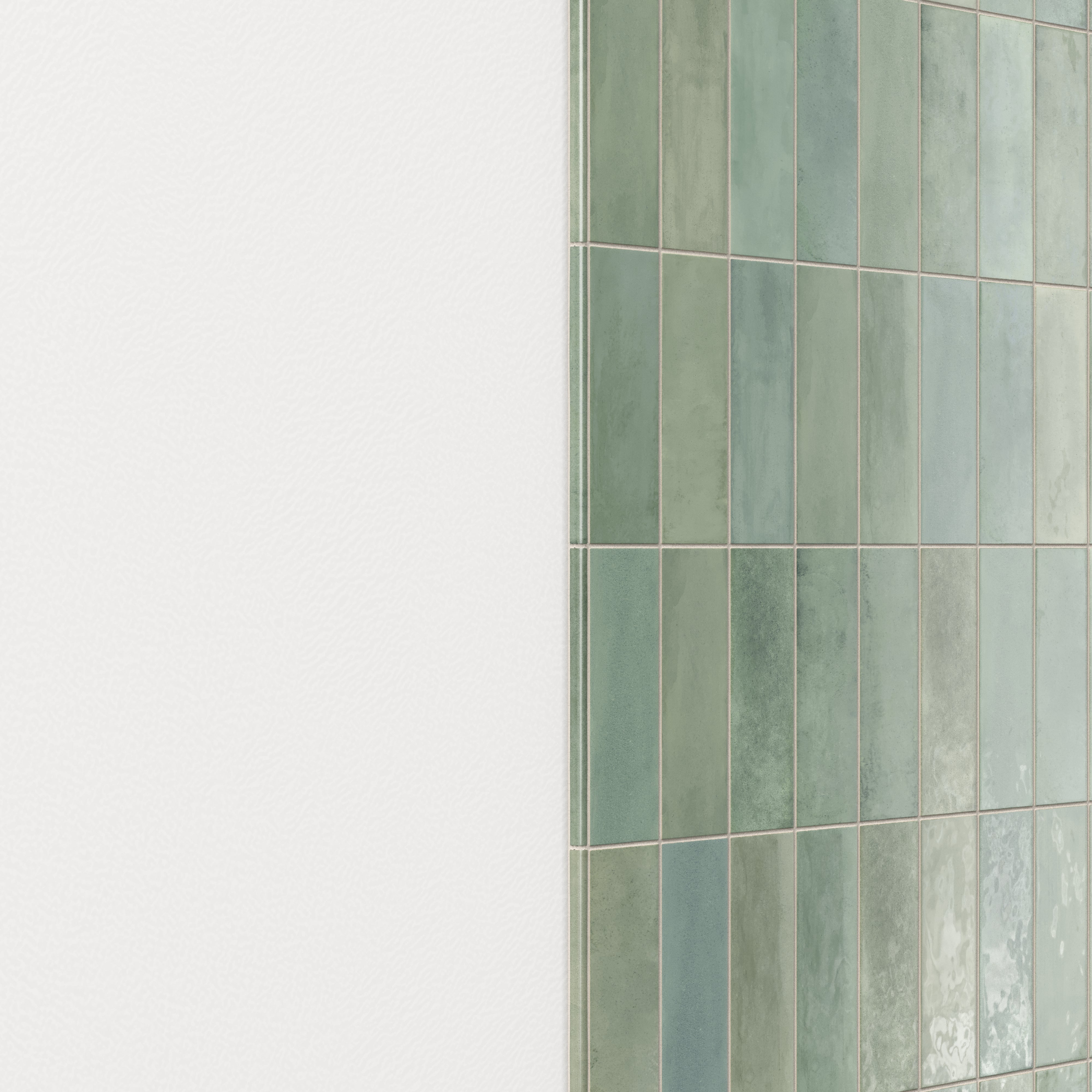 Wall finished with glossy ceramic subway tiles in shifting green tones, highlighted by a rounded tile edge trim for a smooth, polished transition