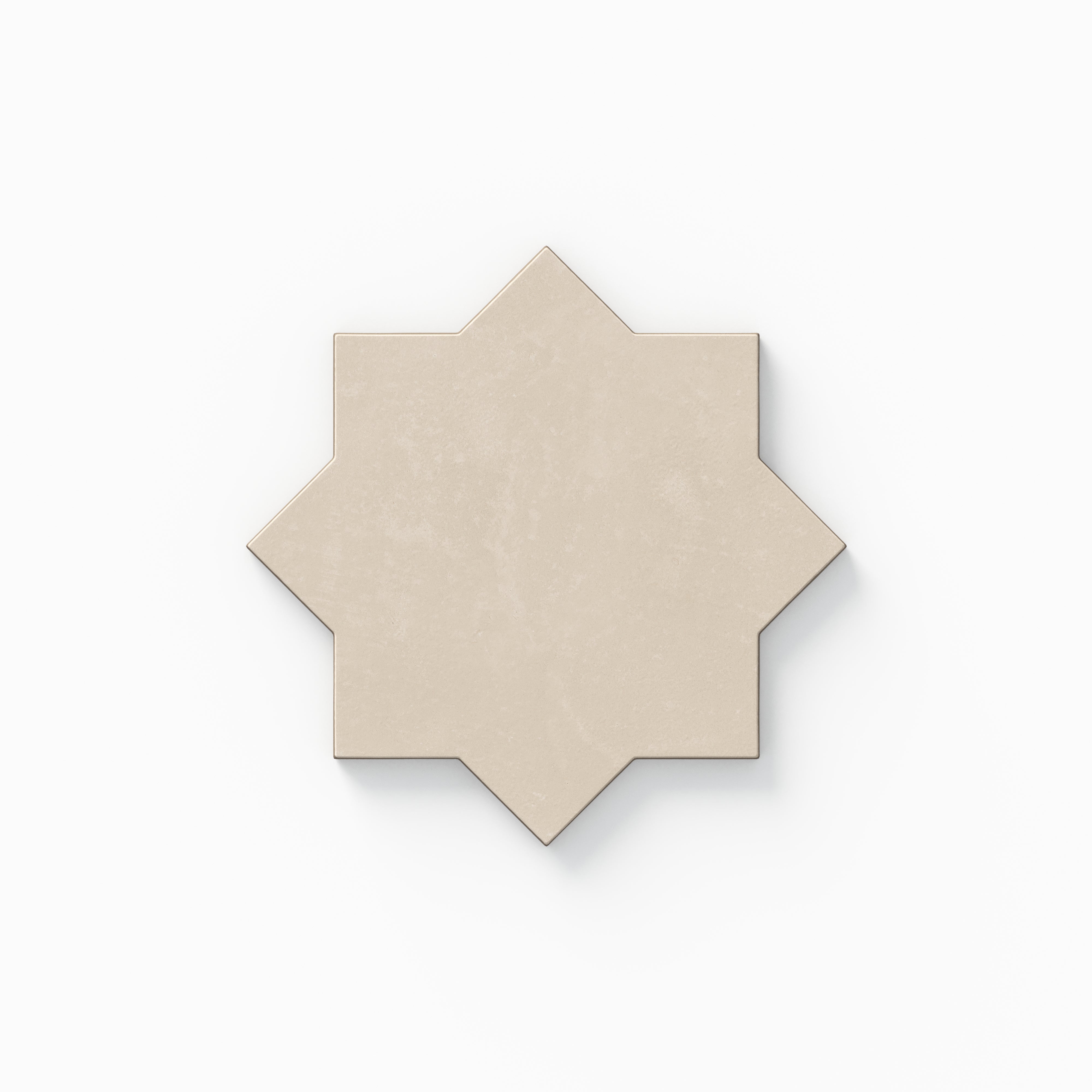 A decorative eight-point star tile from our Isabel 11x11 Matte Porcelain Star and Cross set, featuring grayish-beige tones with subtle cement-plaster texture and a soft, powdery aged finish.